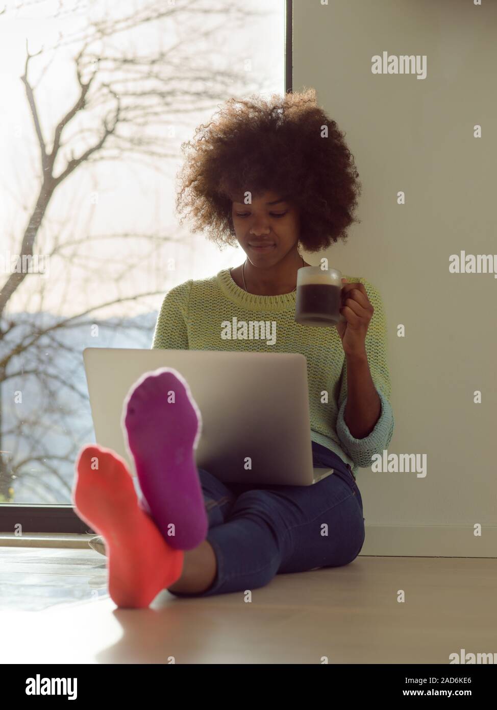 black woman in the living room on the floor Stock Photo - Alamy