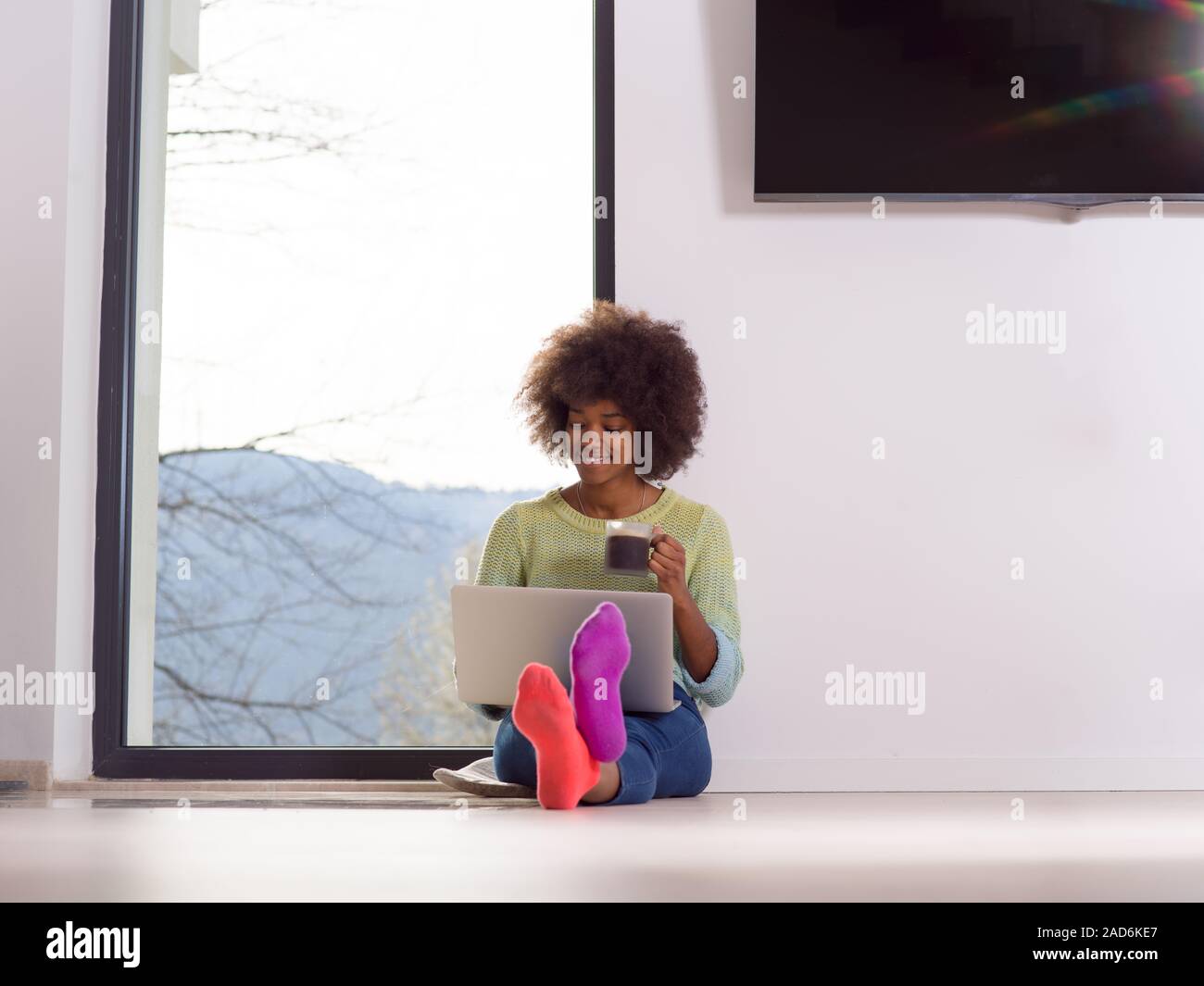 black woman in the living room on the floor Stock Photo - Alamy