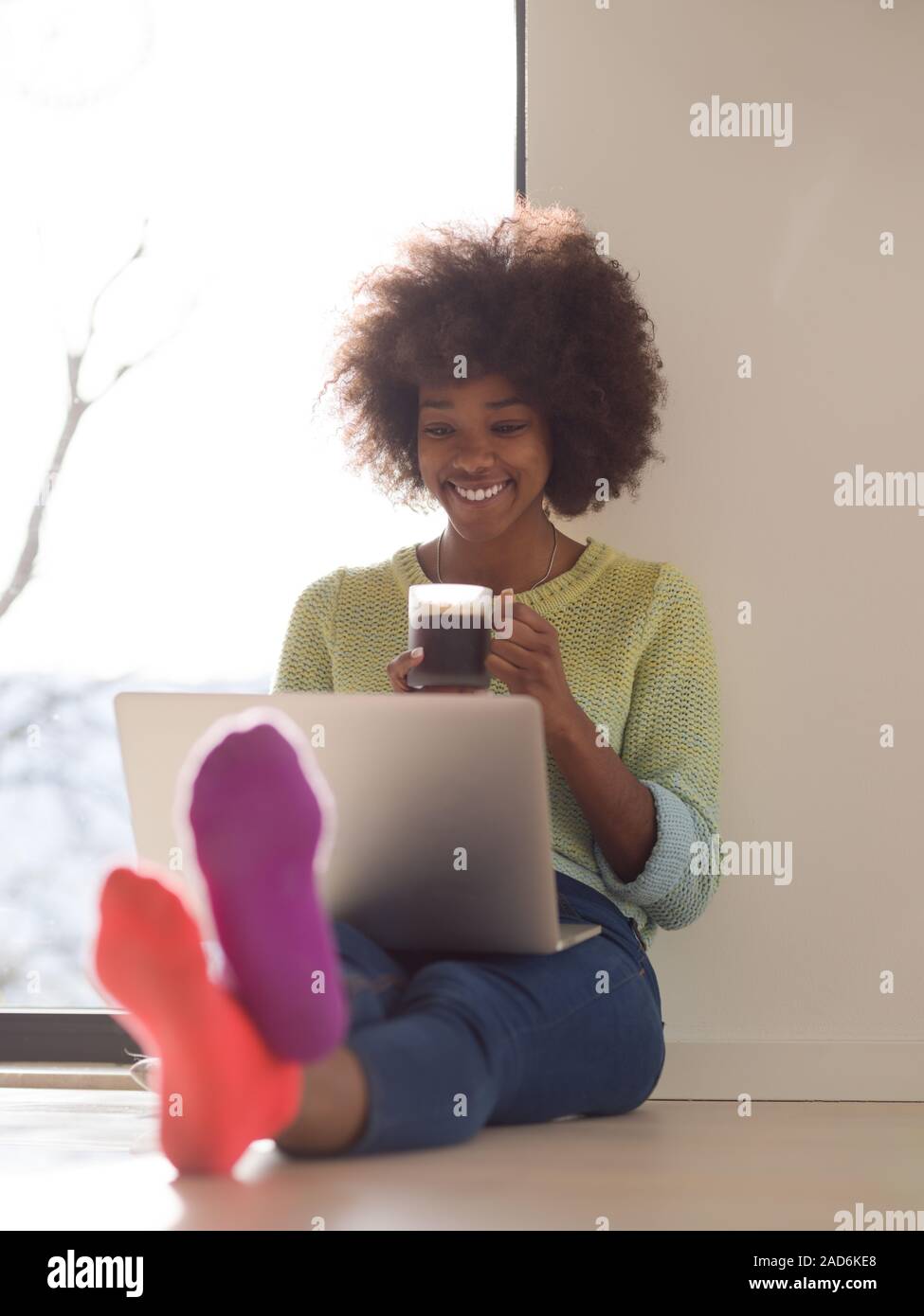 black woman in the living room on the floor Stock Photo - Alamy