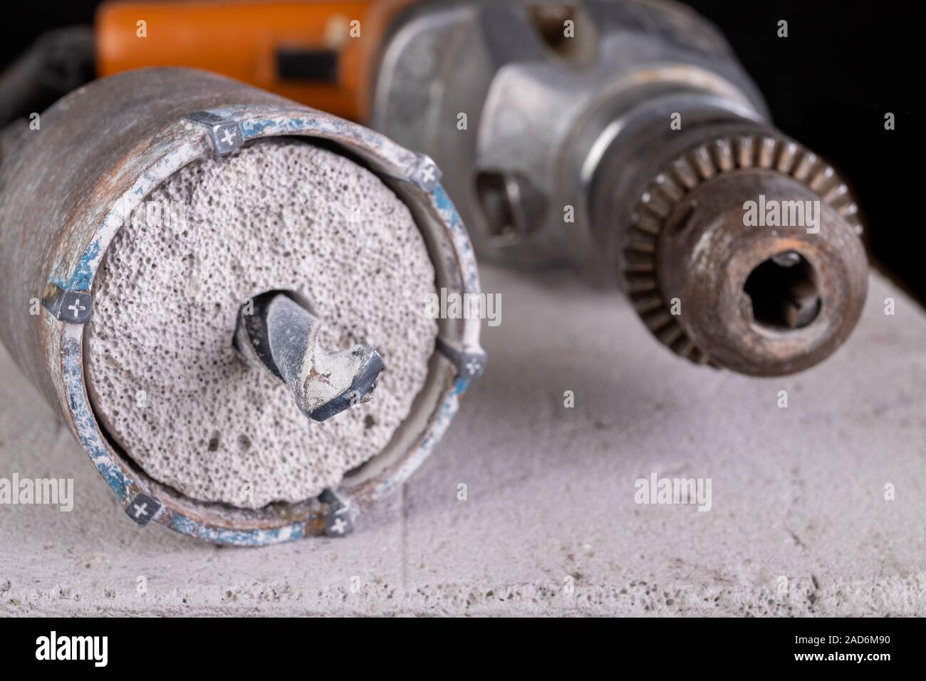 Drilling large diameter holes in concrete with a hole saw. Construction