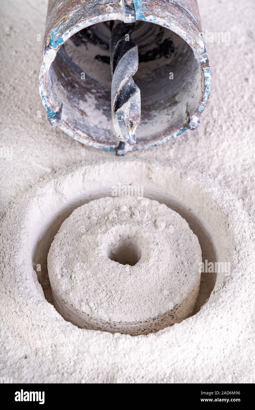 Drilling large diameter holes in concrete with a hole saw. Construction