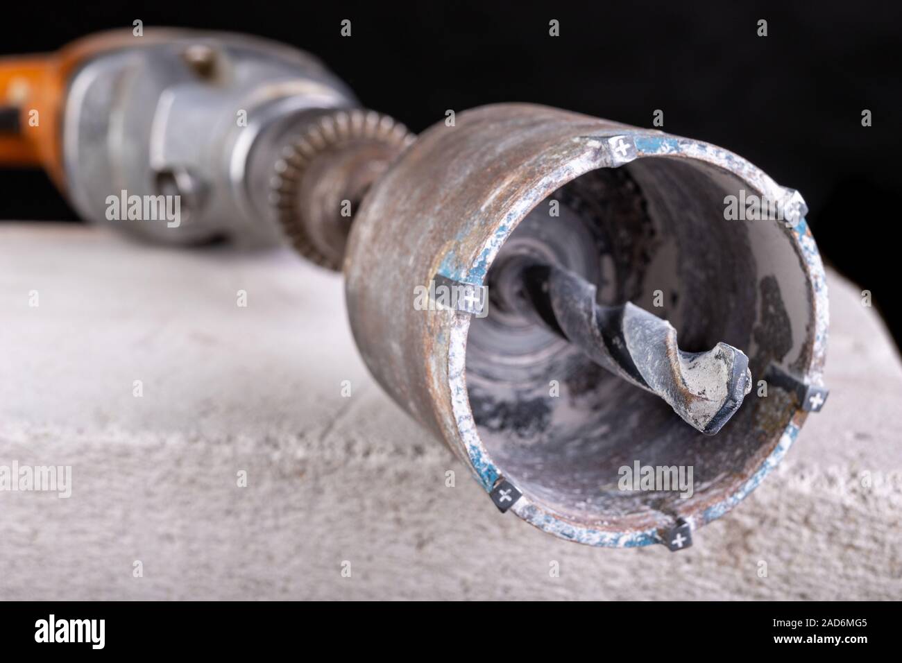 Drilling large diameter holes in concrete with a hole saw. Construction