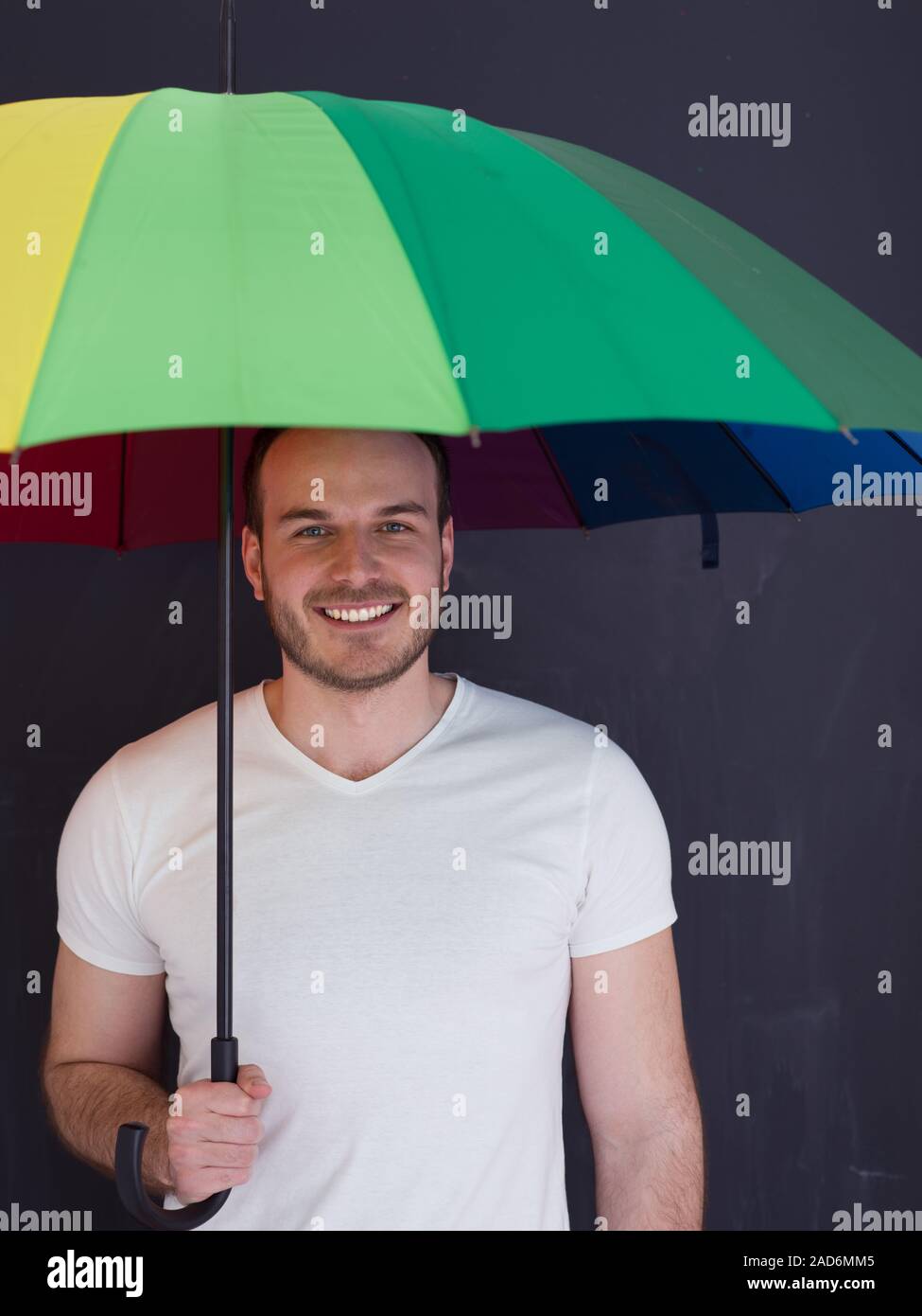 handsome man with a colorful umbrella Stock Photo - Alamy