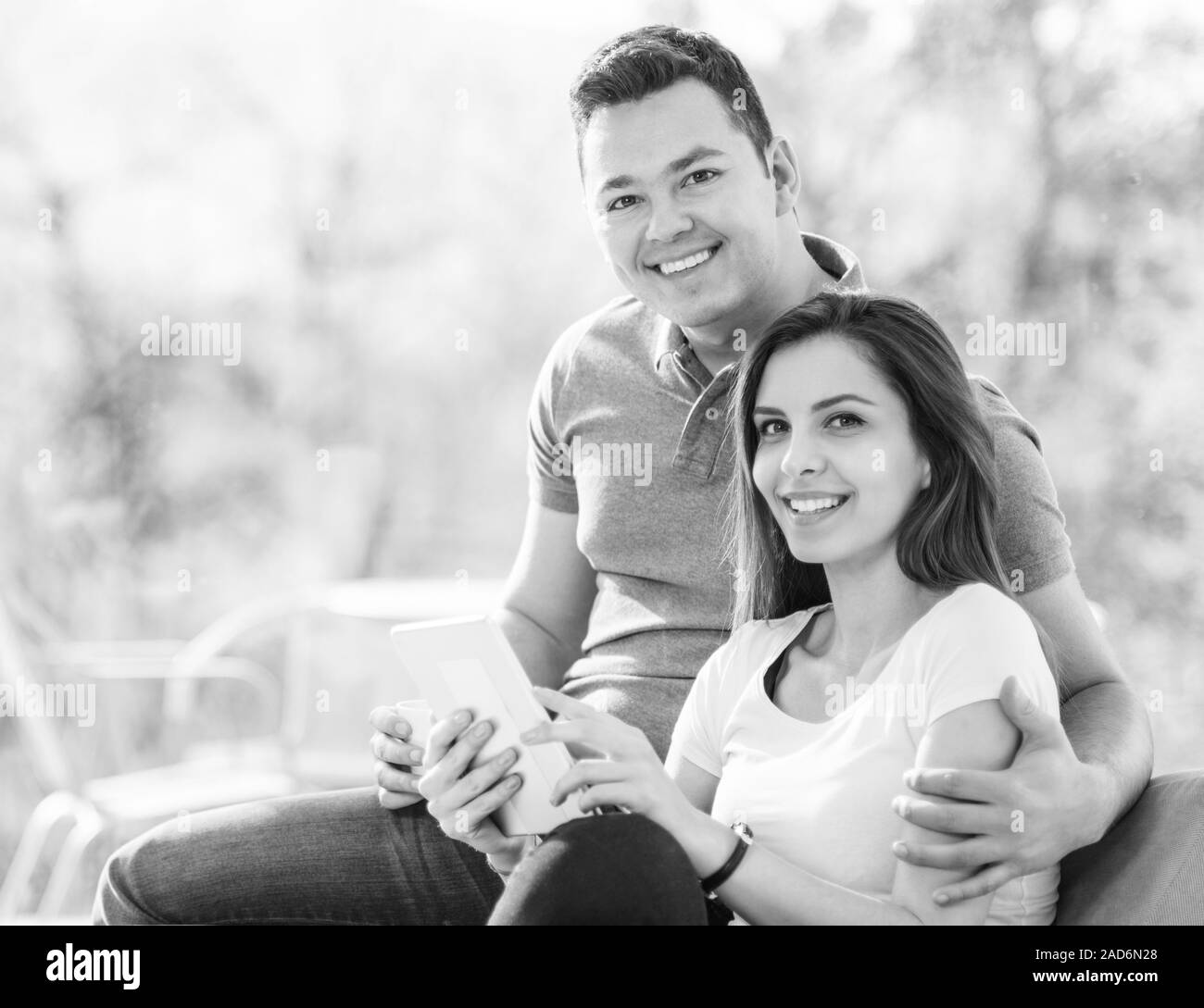 Two cheerful lovers sitting on the couch Stock Photo