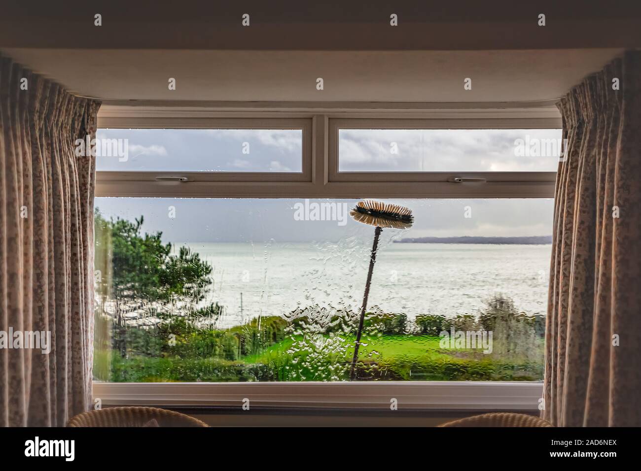 A Double Glazed Picture Window With Small Top Light Opening Windows Being Cleaned With An Extension Brush And Pure Water Some Motion Blur Showing The Stock Photo Alamy