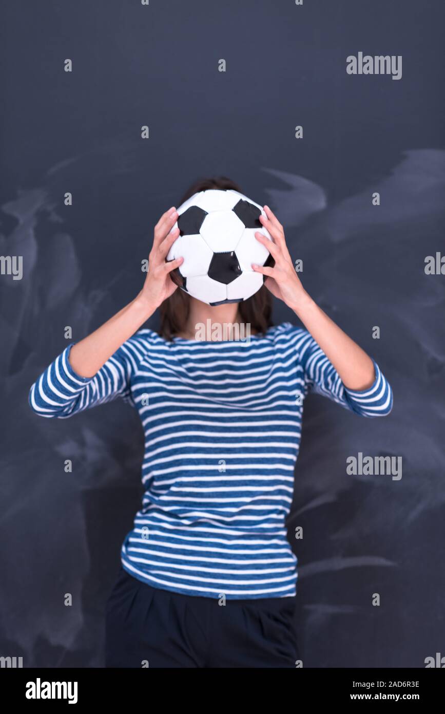 woman holding a soccer ball in front of chalk drawing board Stock Photo ...