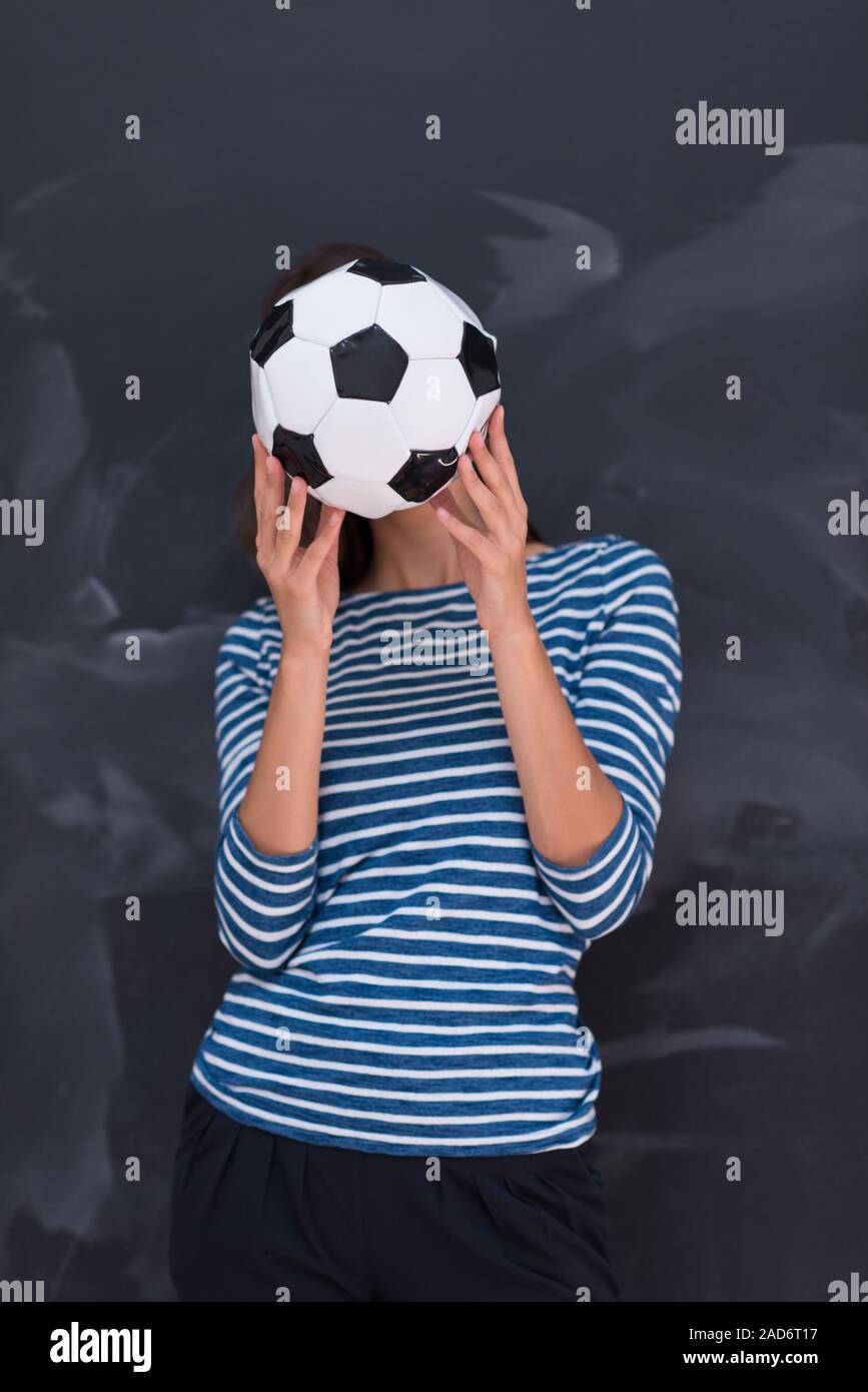 woman holding a soccer ball in front of chalk drawing board Stock Photo ...