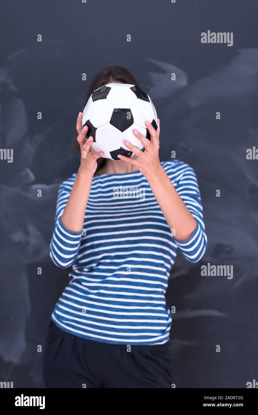 woman holding a soccer ball in front of chalk drawing board Stock Photo ...