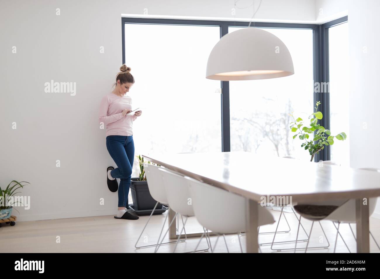 young woman using tablet computer on the floor Stock Photo