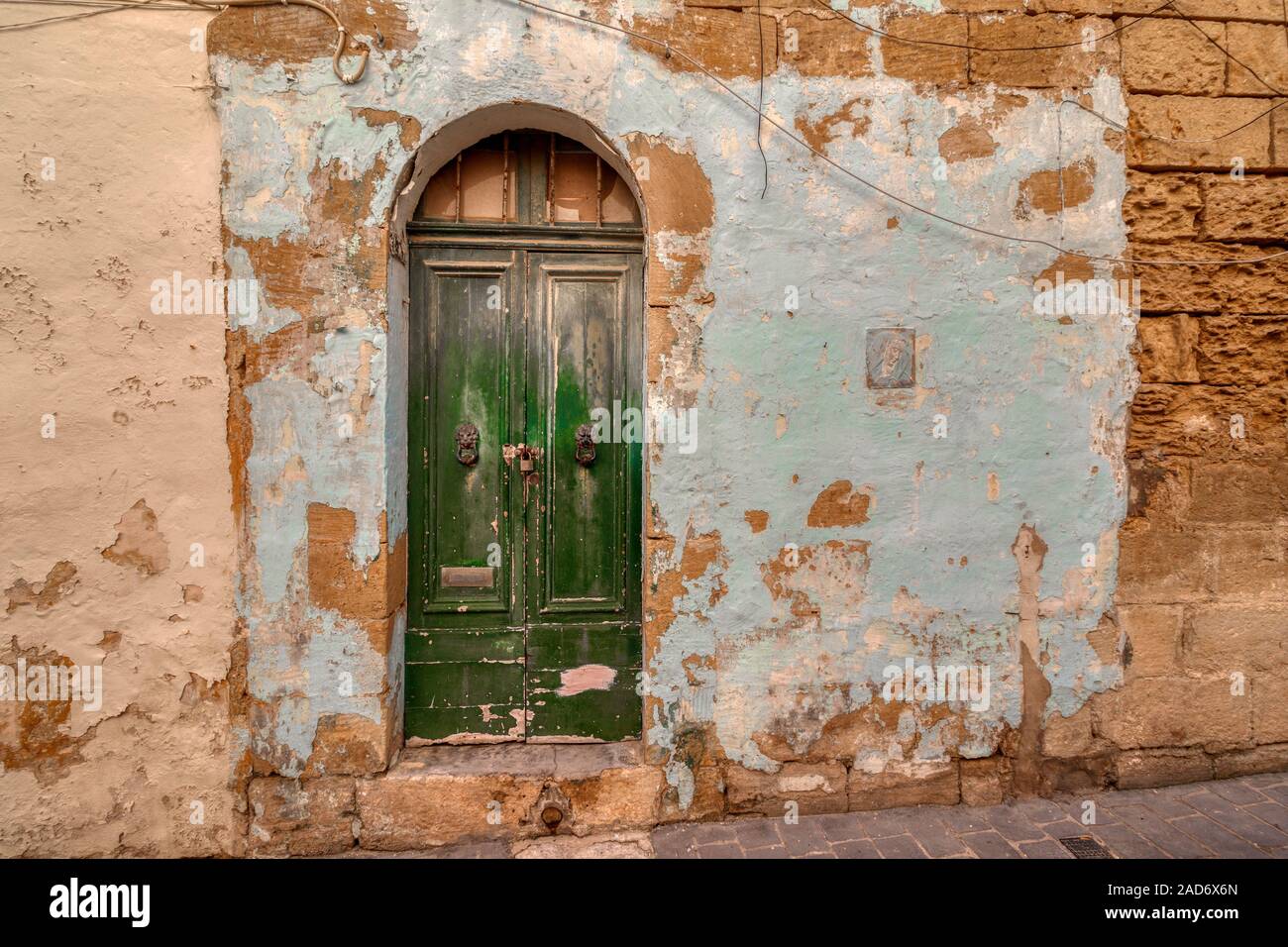 Badly Eroded And Weathered Painted Green Double Door Entrance To A