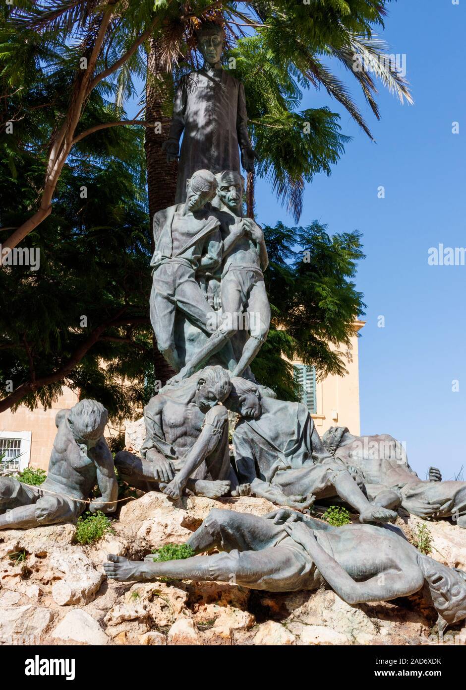 1986 Monument to Dun Mikiel Xerri, an C18 Maltese patriot, by sculptor Anton Agius. Located beneath a large palm tree in Independence Square, Valletta Stock Photo