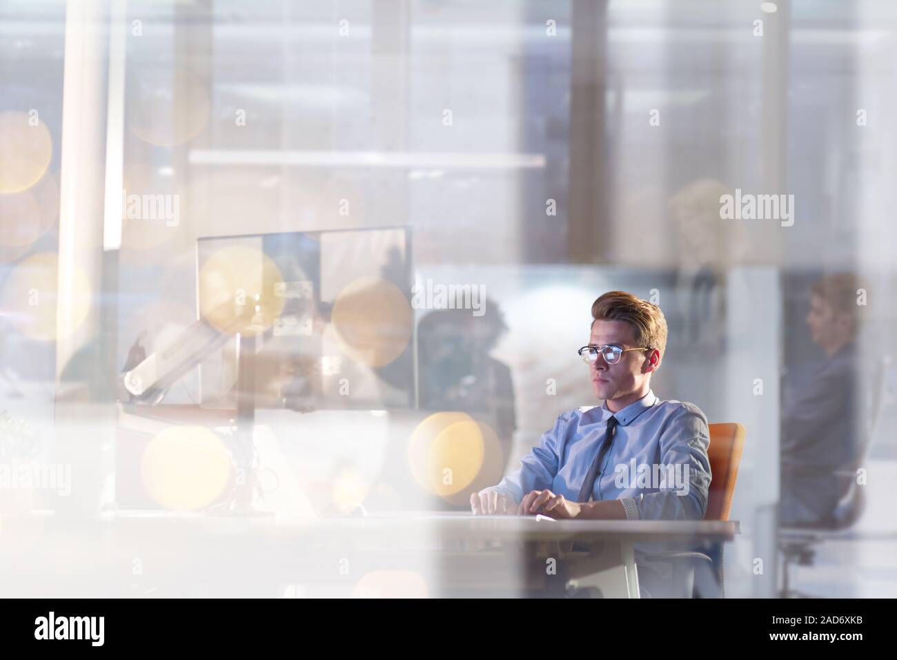 man working on computer in dark office Stock Photo
