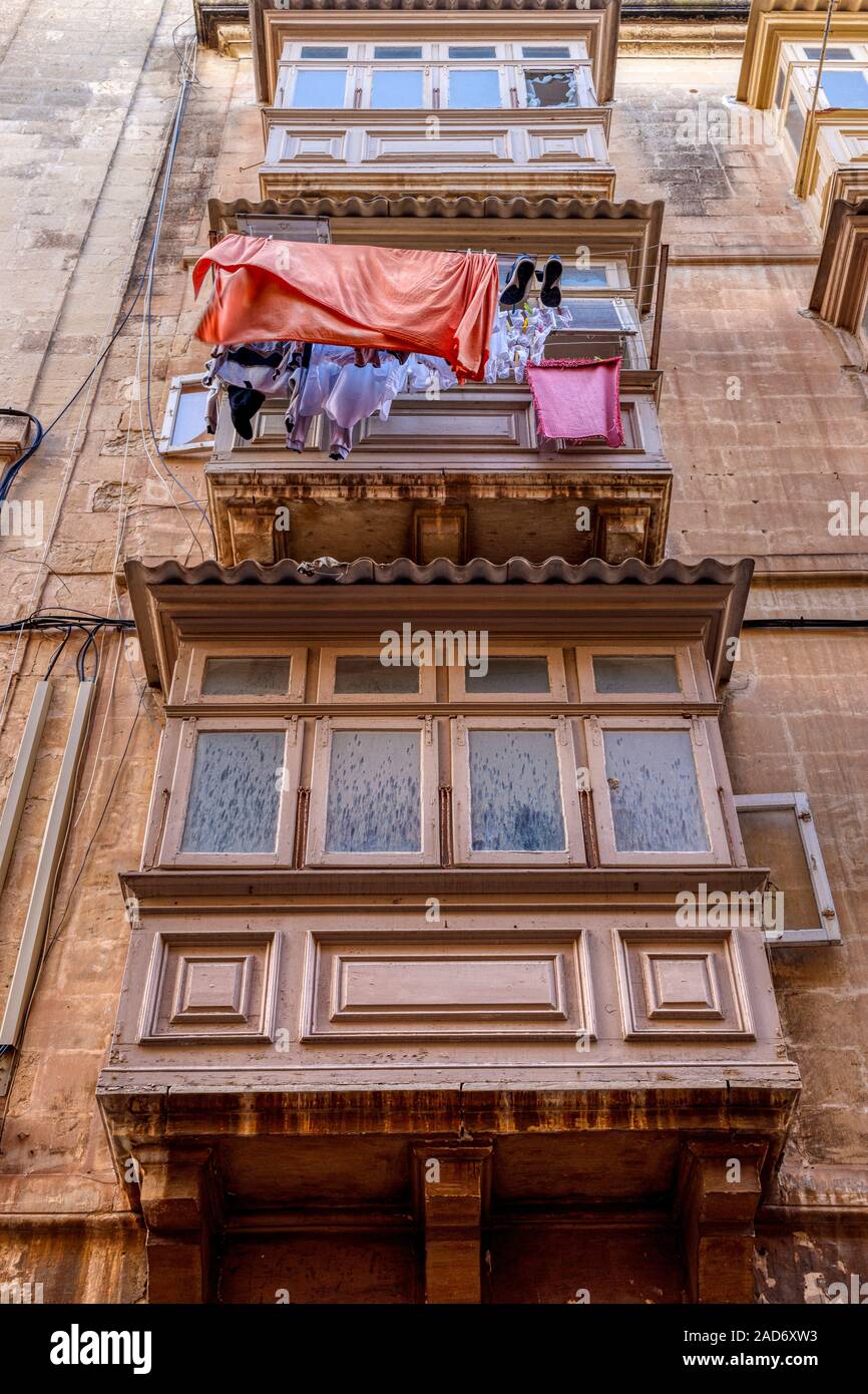 A traditional building front with enclosed balconies on supports known as saljaturi, Valletta, Malta. Stock Photo
