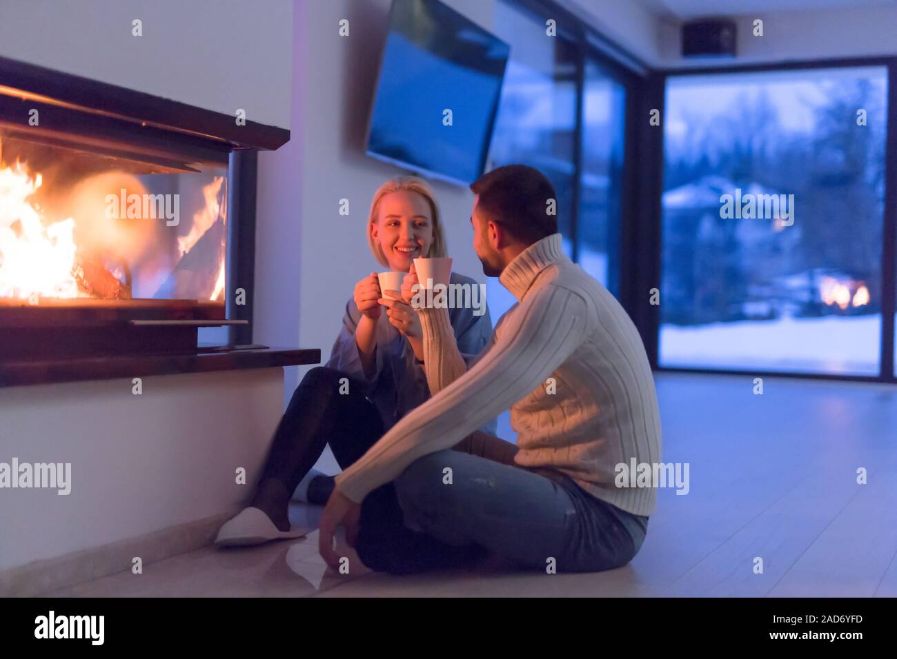 happy couple in front of fireplace Stock Photo