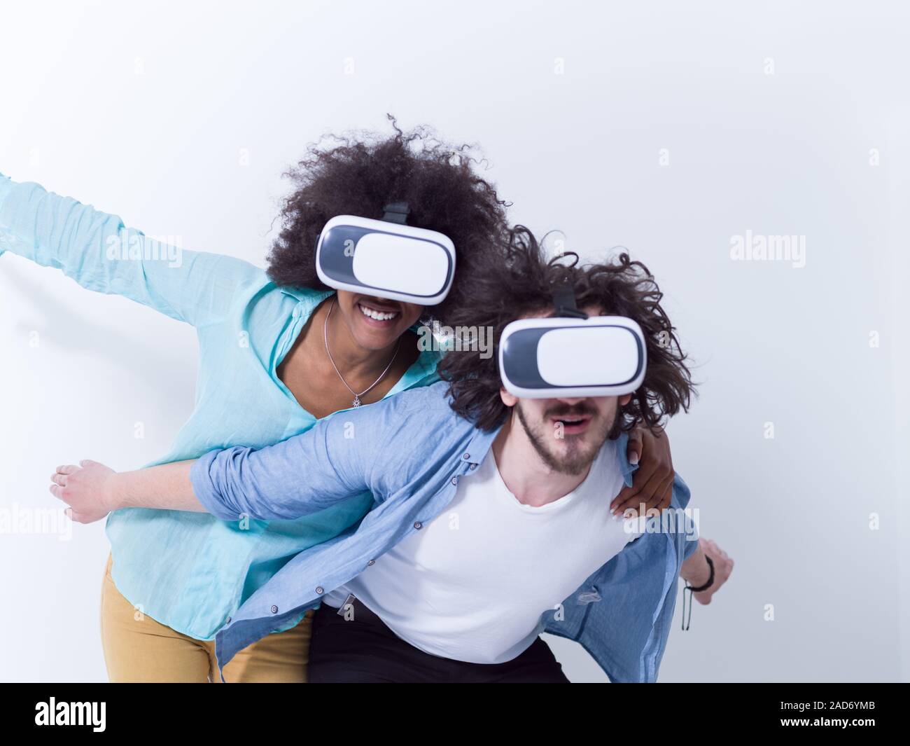 multiethnic couple getting experience using VR headset glasses Stock Photo