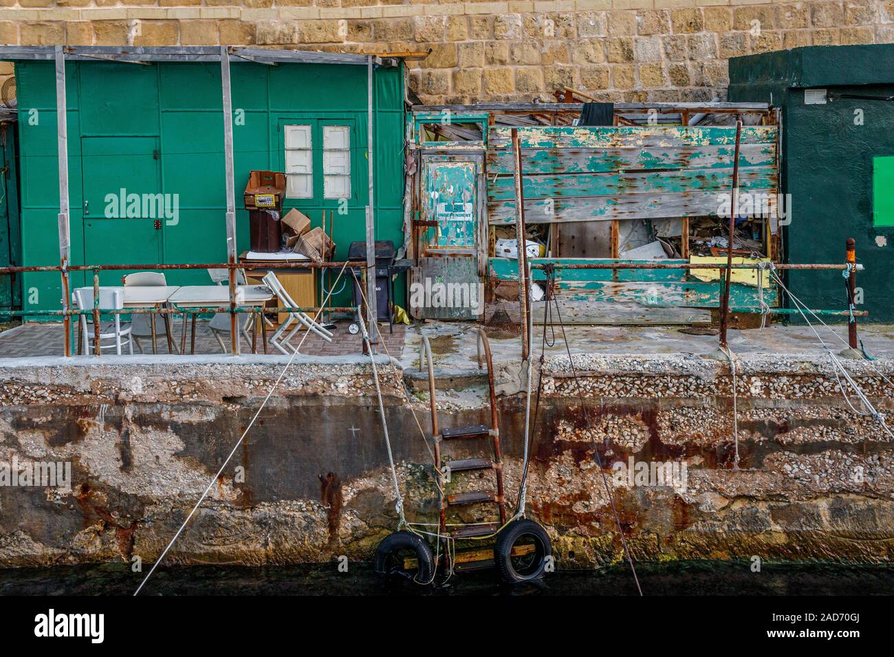 Fisherman's dockside facilities at Valletta, Malta. Assorted sheds and homemade storage units. Stock Photo