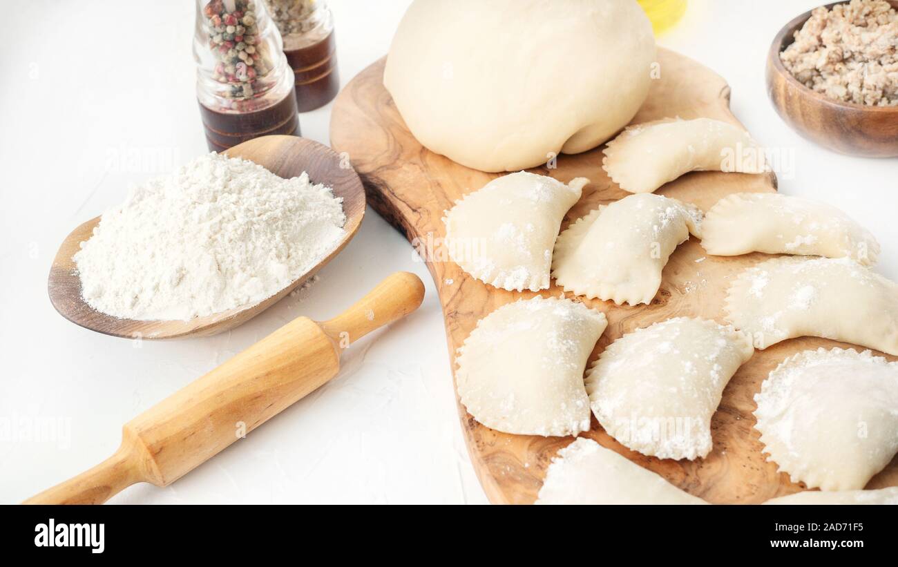 Cooking homemade dumplings from raw homemade dough. National cuisine of Slavic peoples. Stock Photo