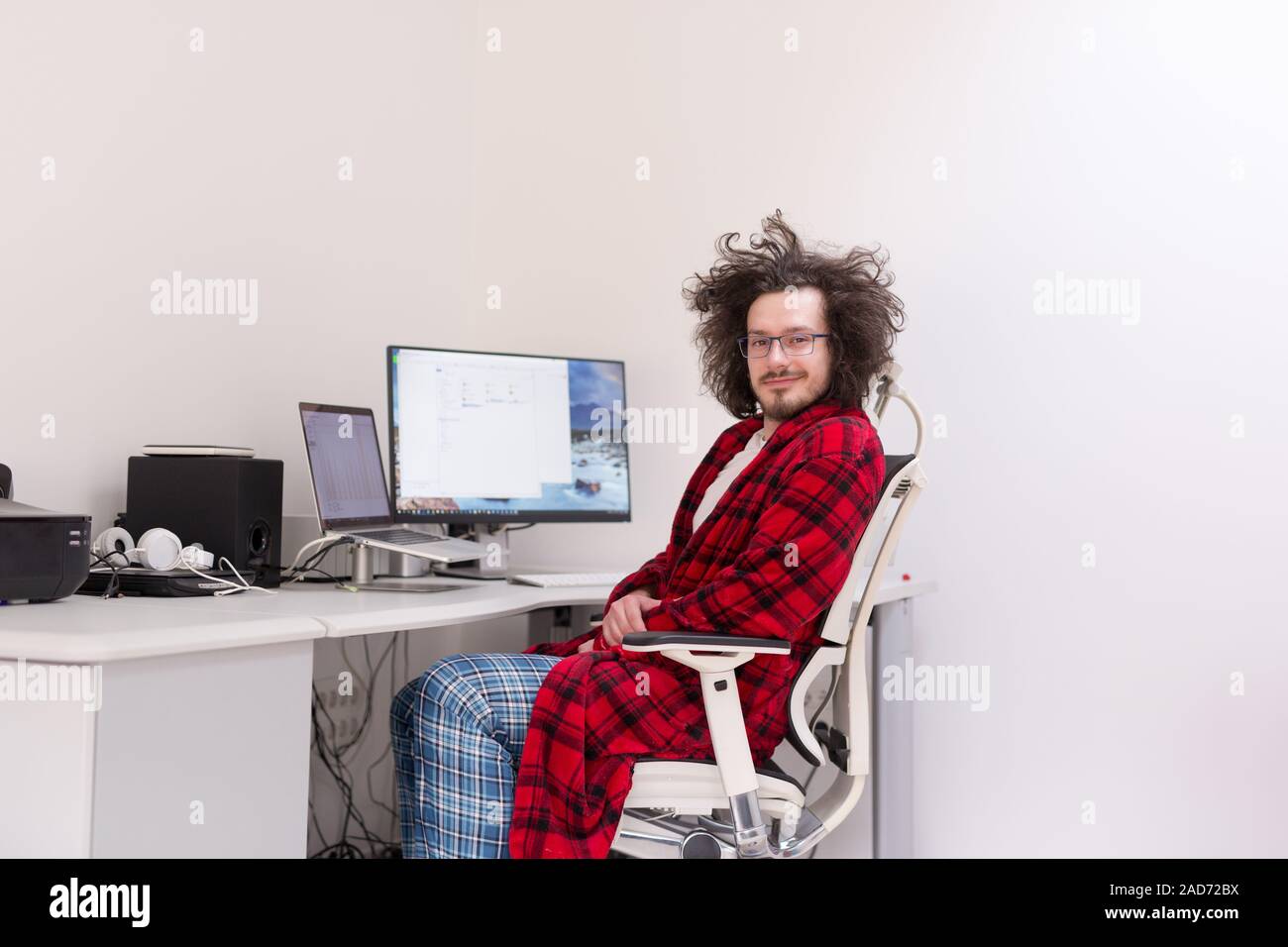 graphic designer in bathrobe working at home Stock Photo