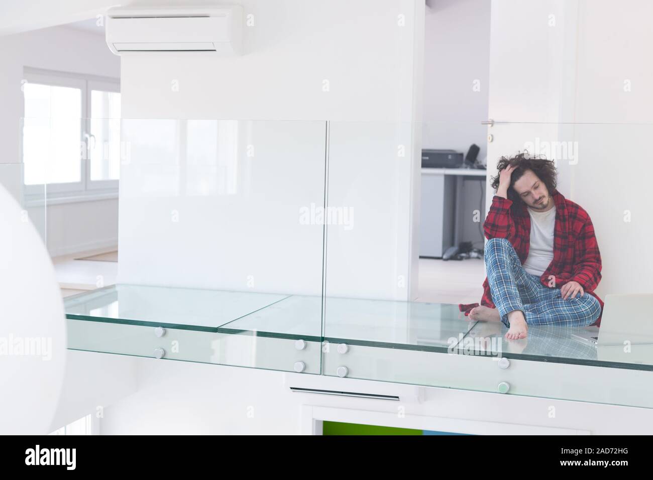 young freelancer in bathrobe working from home Stock Photo