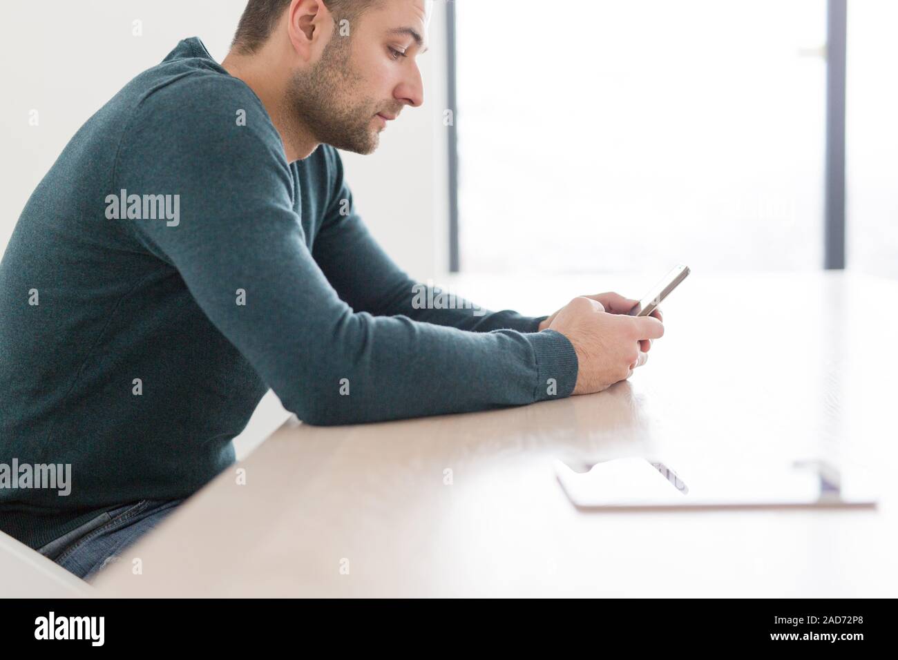 Young casual Businessman using smartphone Stock Photo