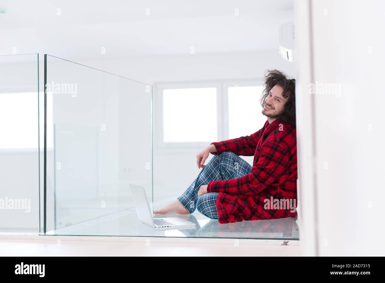 young freelancer in bathrobe working from home Stock Photo