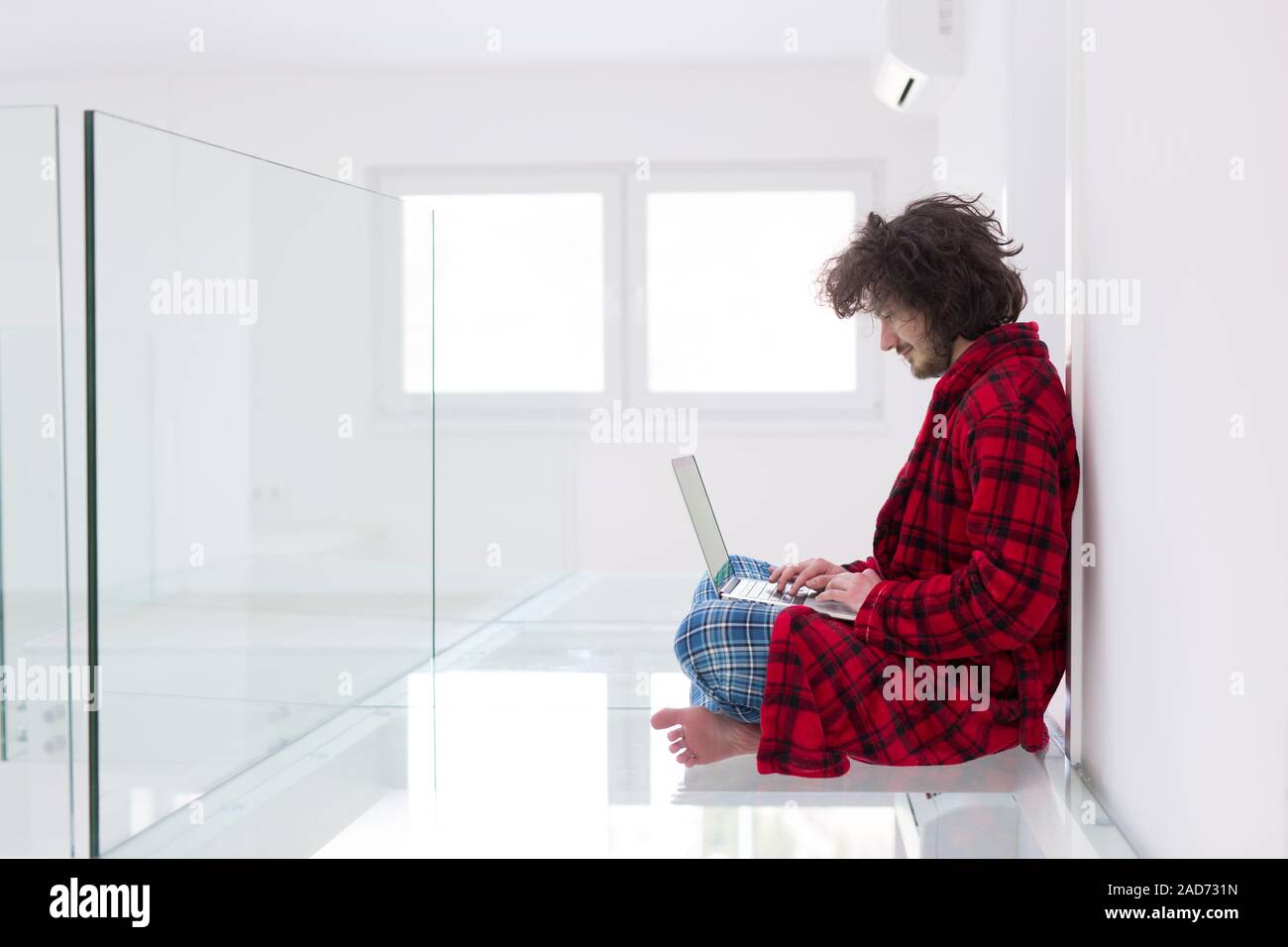 young freelancer in bathrobe working from home Stock Photo