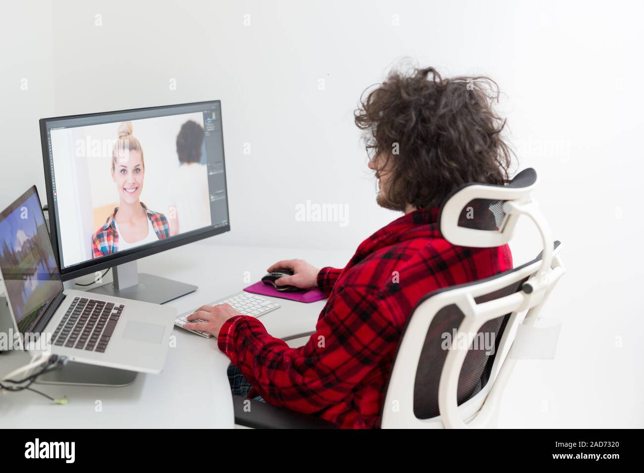graphic designer in bathrobe working at home Stock Photo