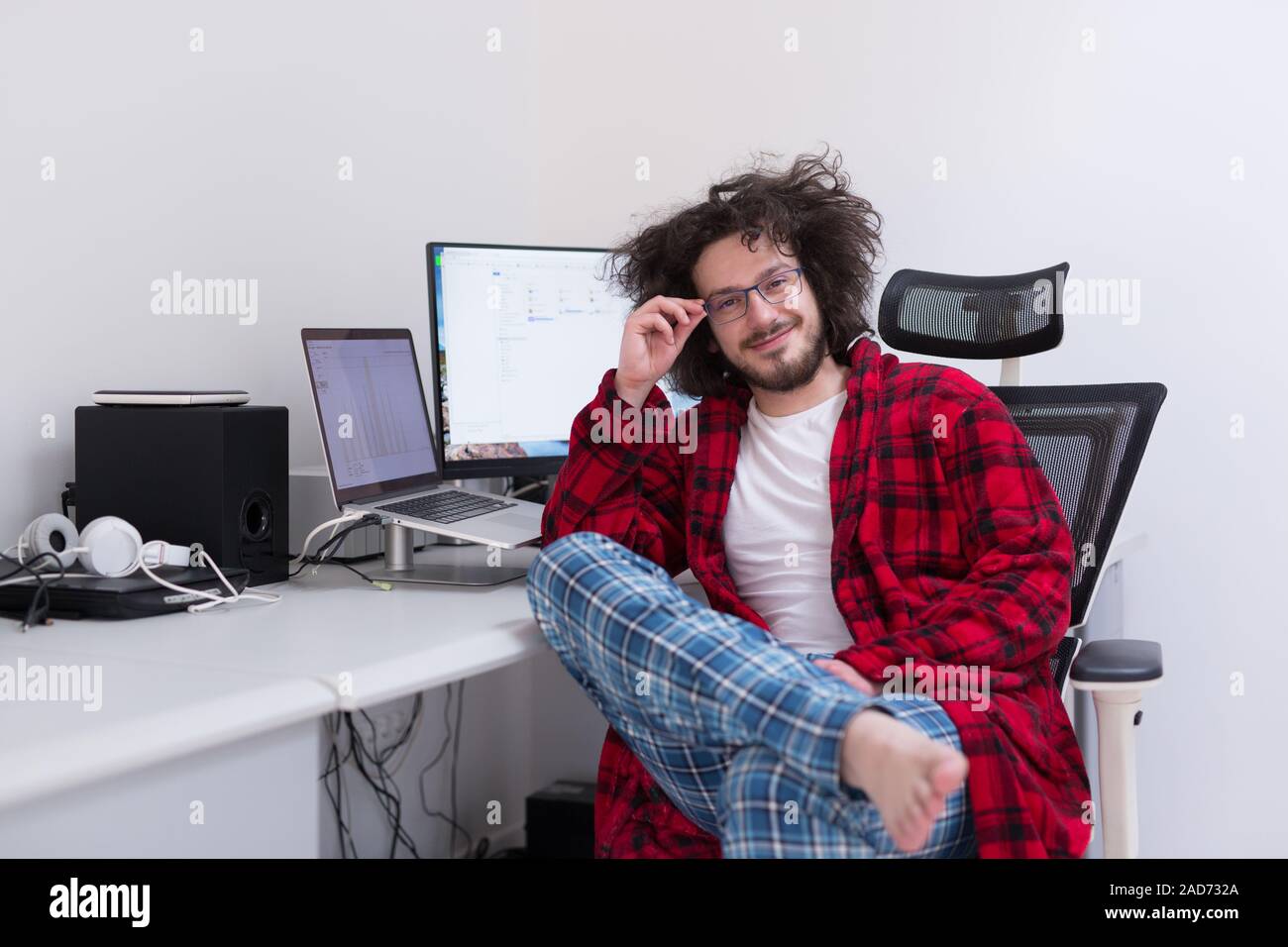 graphic designer in bathrobe working at home Stock Photo
