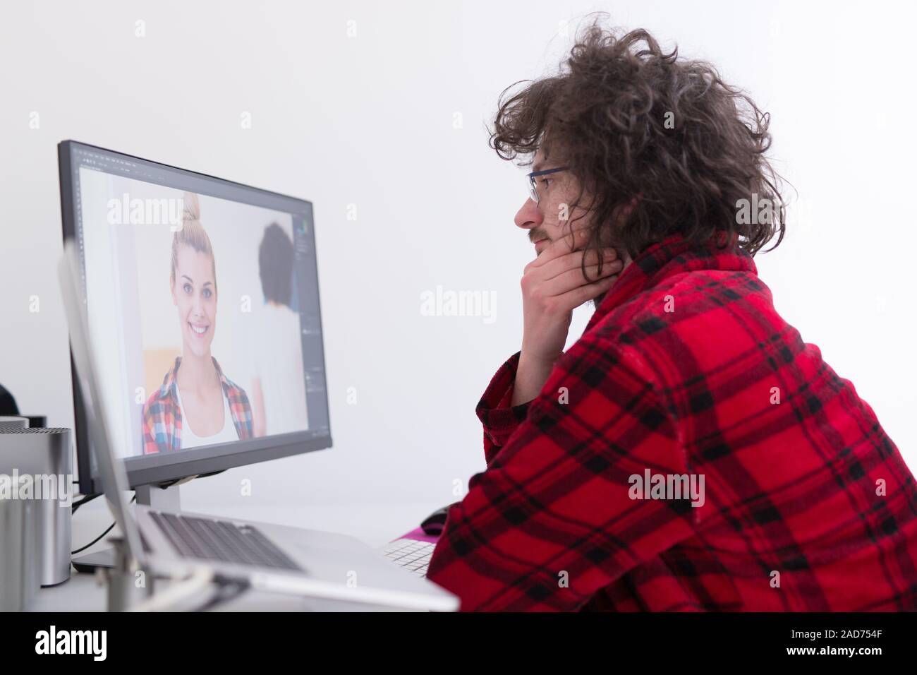 graphic designer in bathrobe working at home Stock Photo