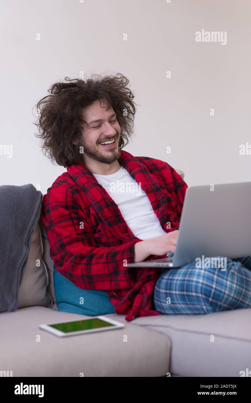 man freelancer in bathrobe working from home Stock Photo