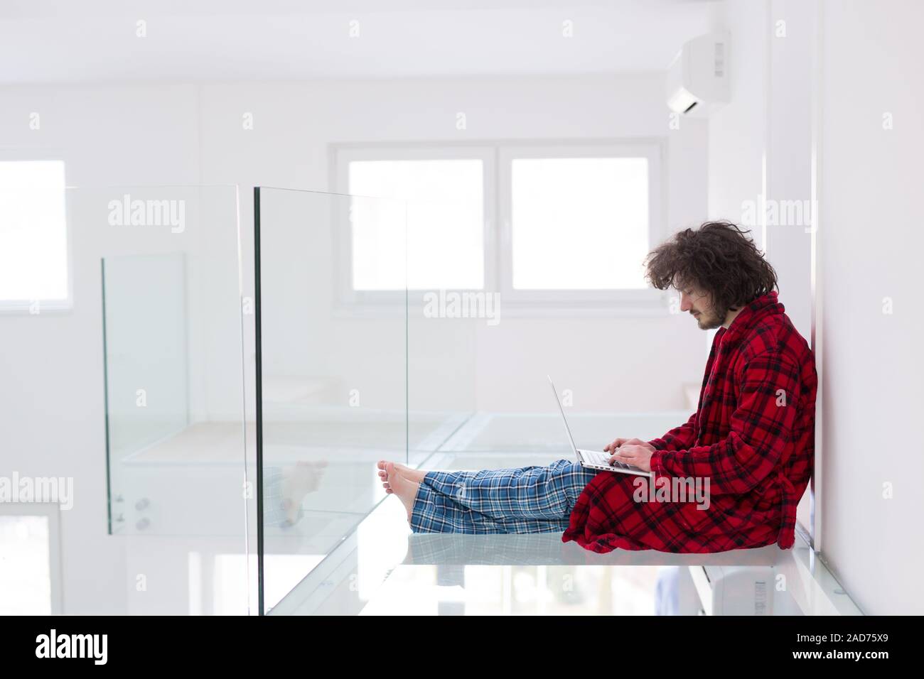 young freelancer in bathrobe working from home Stock Photo