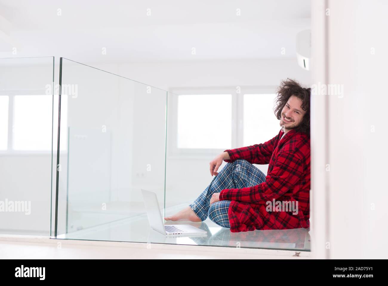 young freelancer in bathrobe working from home Stock Photo