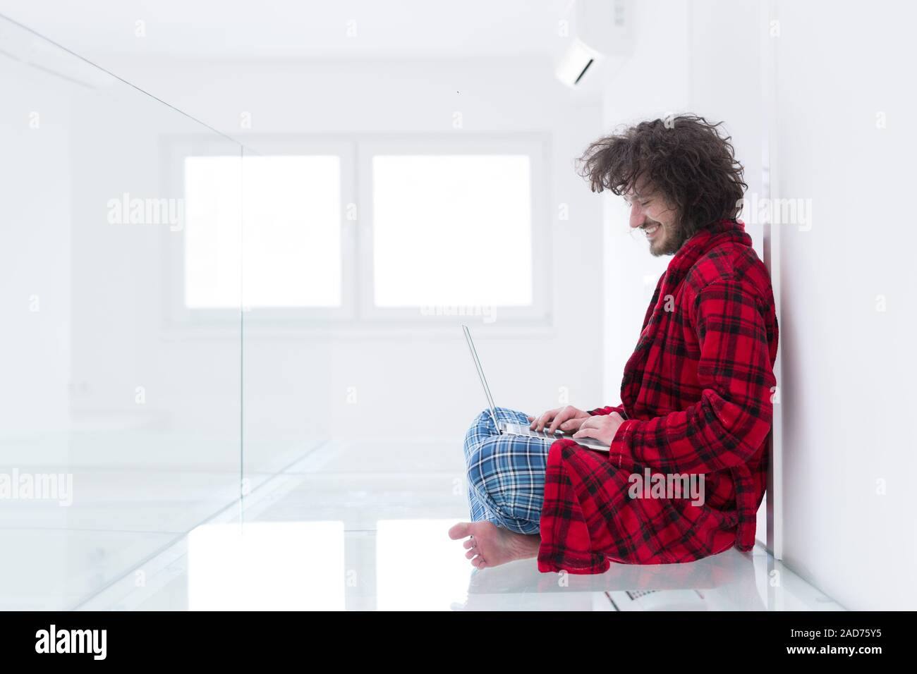 young freelancer in bathrobe working from home Stock Photo