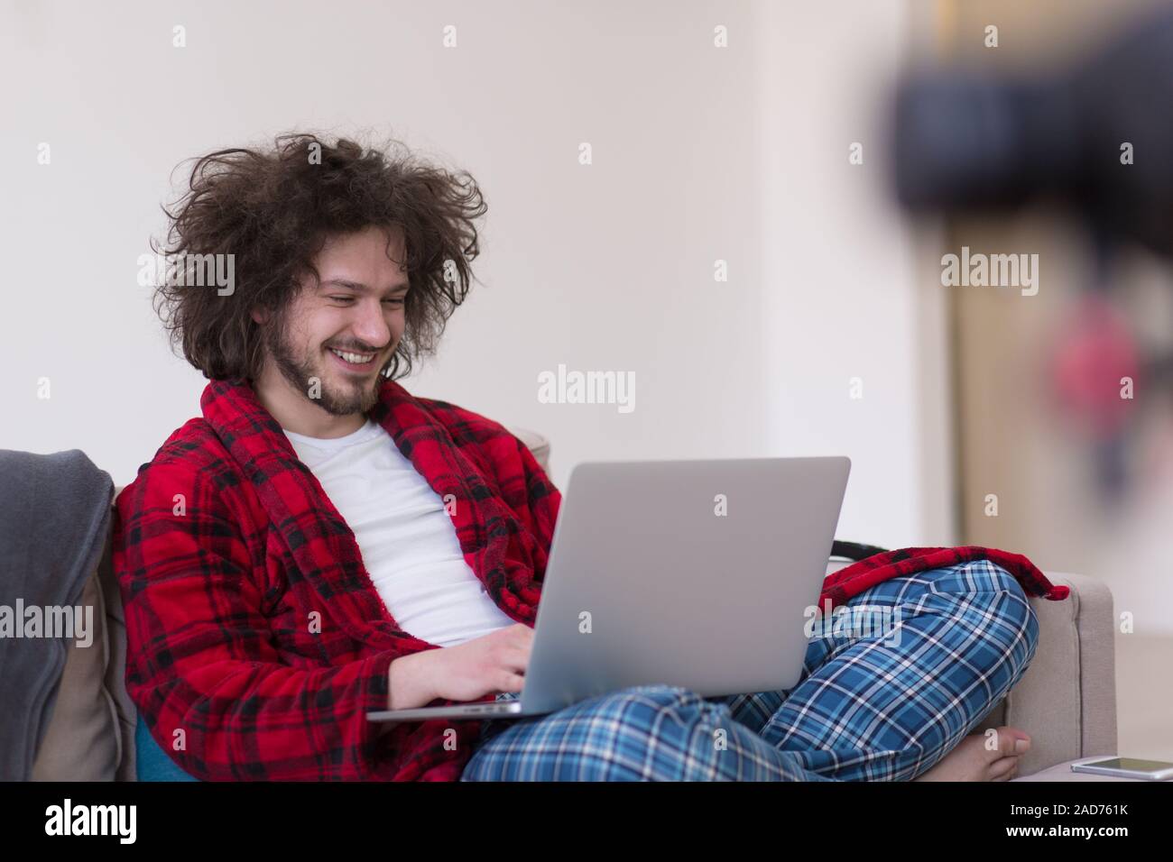 man freelancer in bathrobe working from home Stock Photo