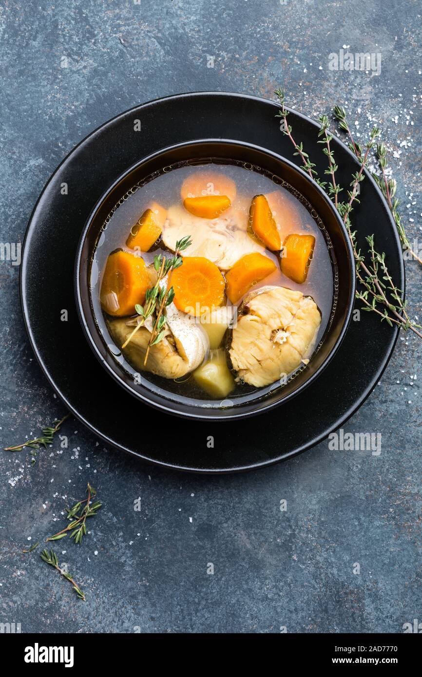 Delicious fresh fish soup with hake in bowl on table. Top view Stock Photo