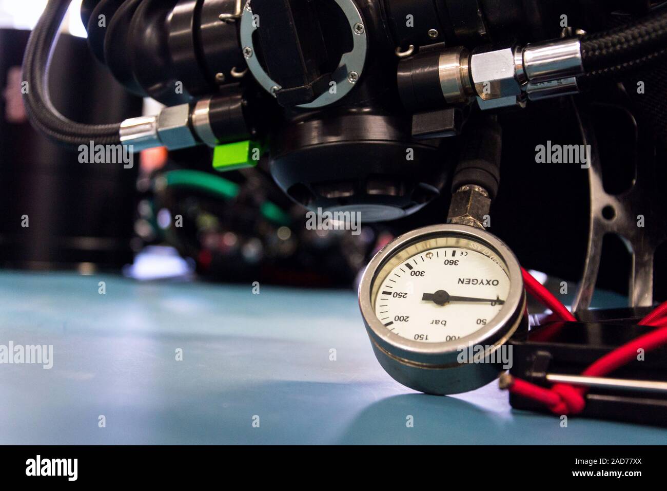 Gas pressure indicator, scuba diving oxygen lying on blue table