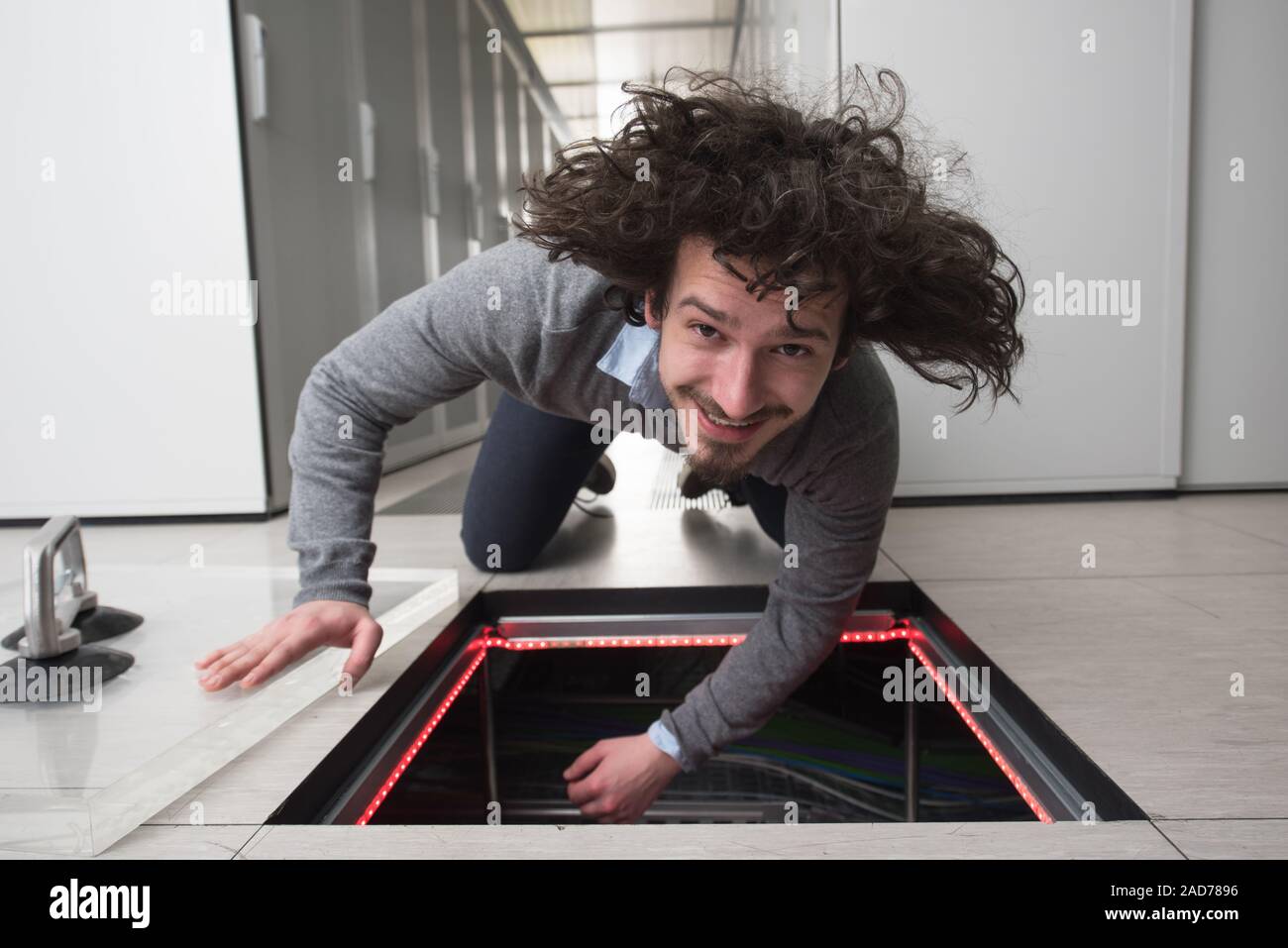 engineer connecting cables in server room Stock Photo