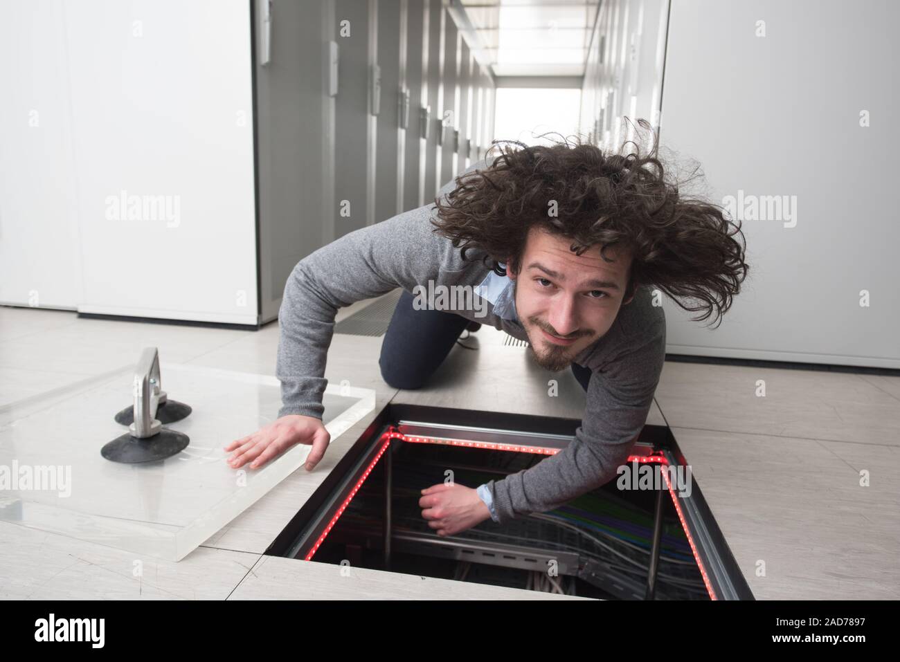 engineer connecting cables in server room Stock Photo