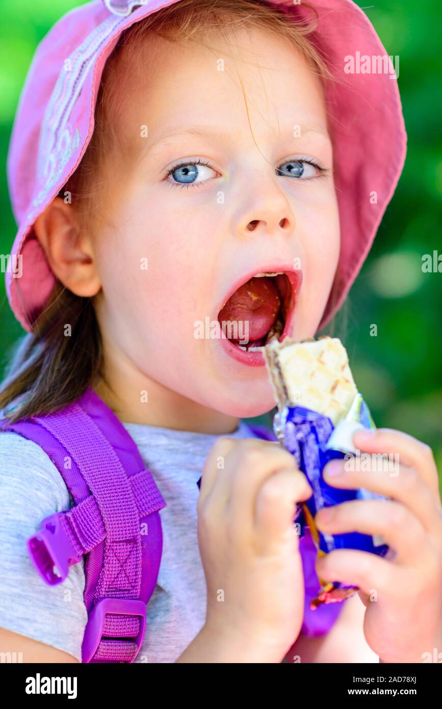 girl eating chocolate wafers - chocolate bar Stock Photo