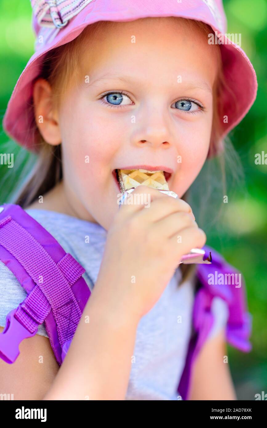 girl eating chocolate wafers chocolate bar Stock Photo Alamy