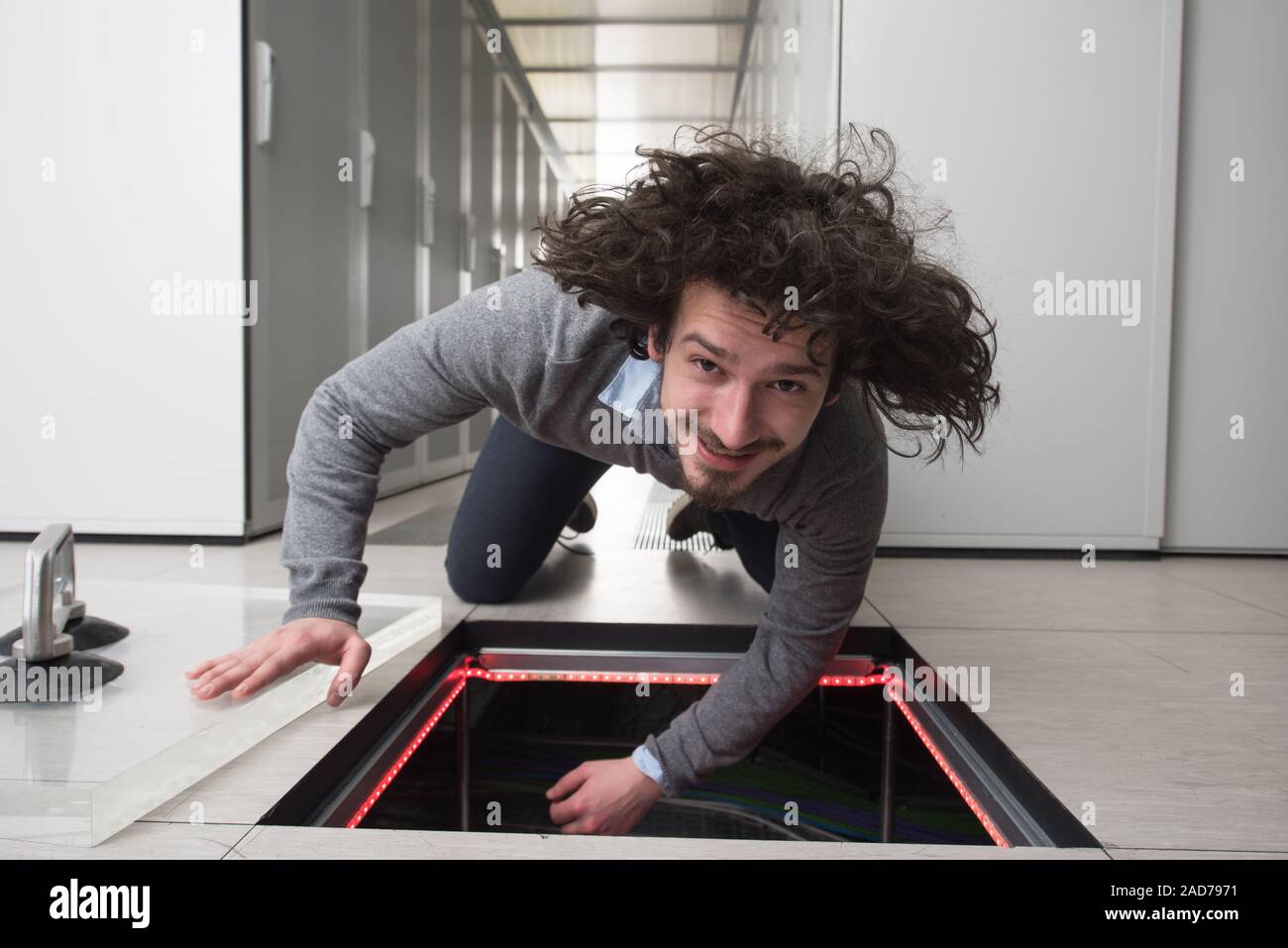 engineer connecting cables in server room Stock Photo
