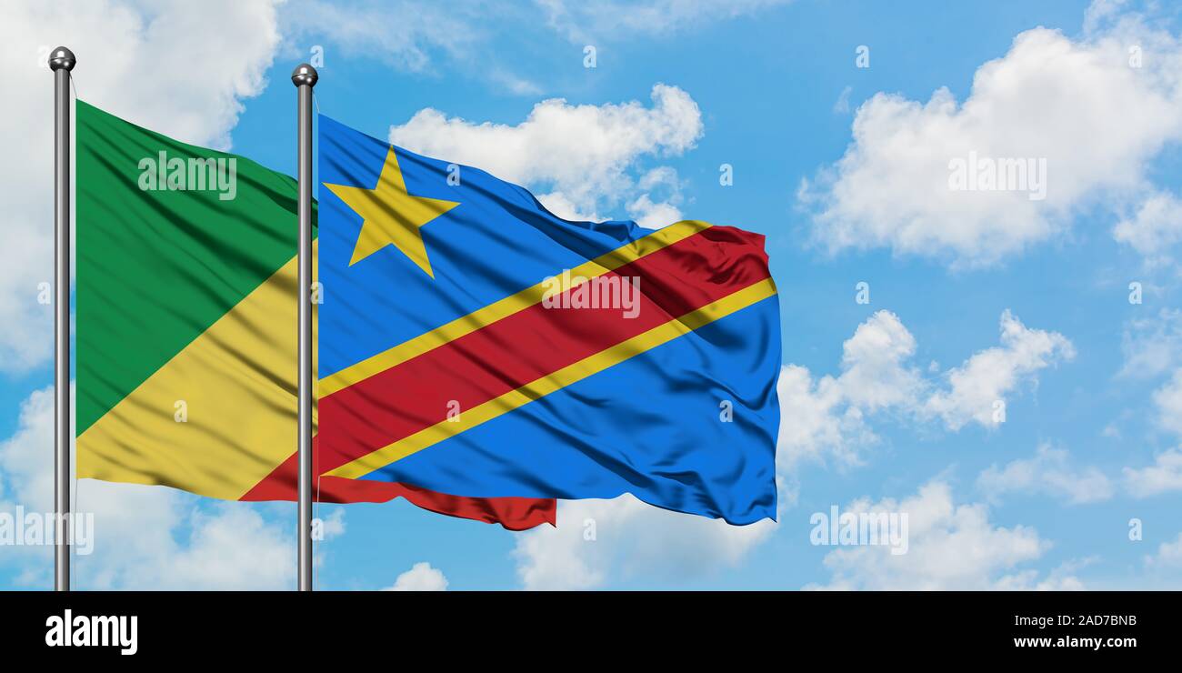 Republic Of The Congo and Congo flag waving in the wind against white cloudy blue sky together. Diplomacy concept, international relations. Stock Photo