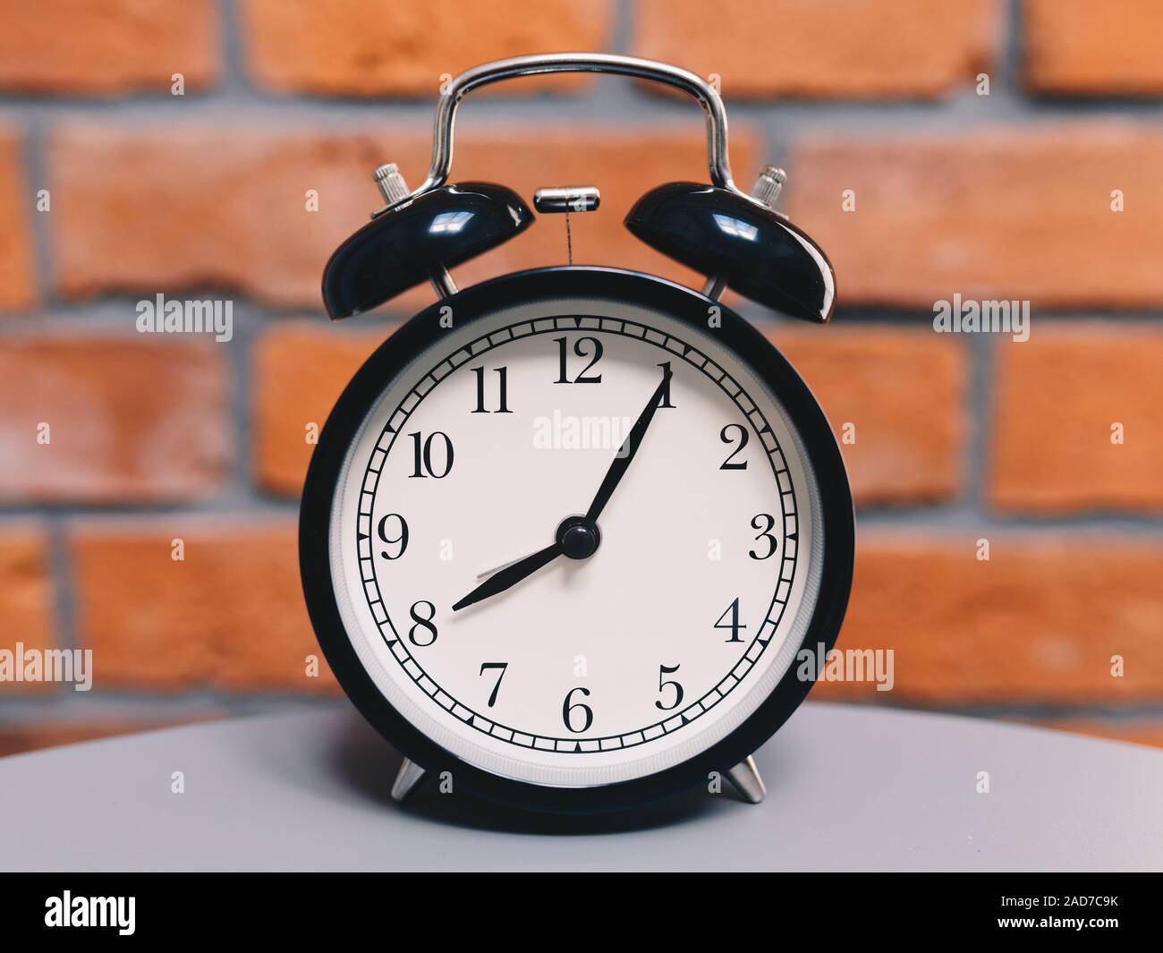 Retro alarm clock on table Stock Photo