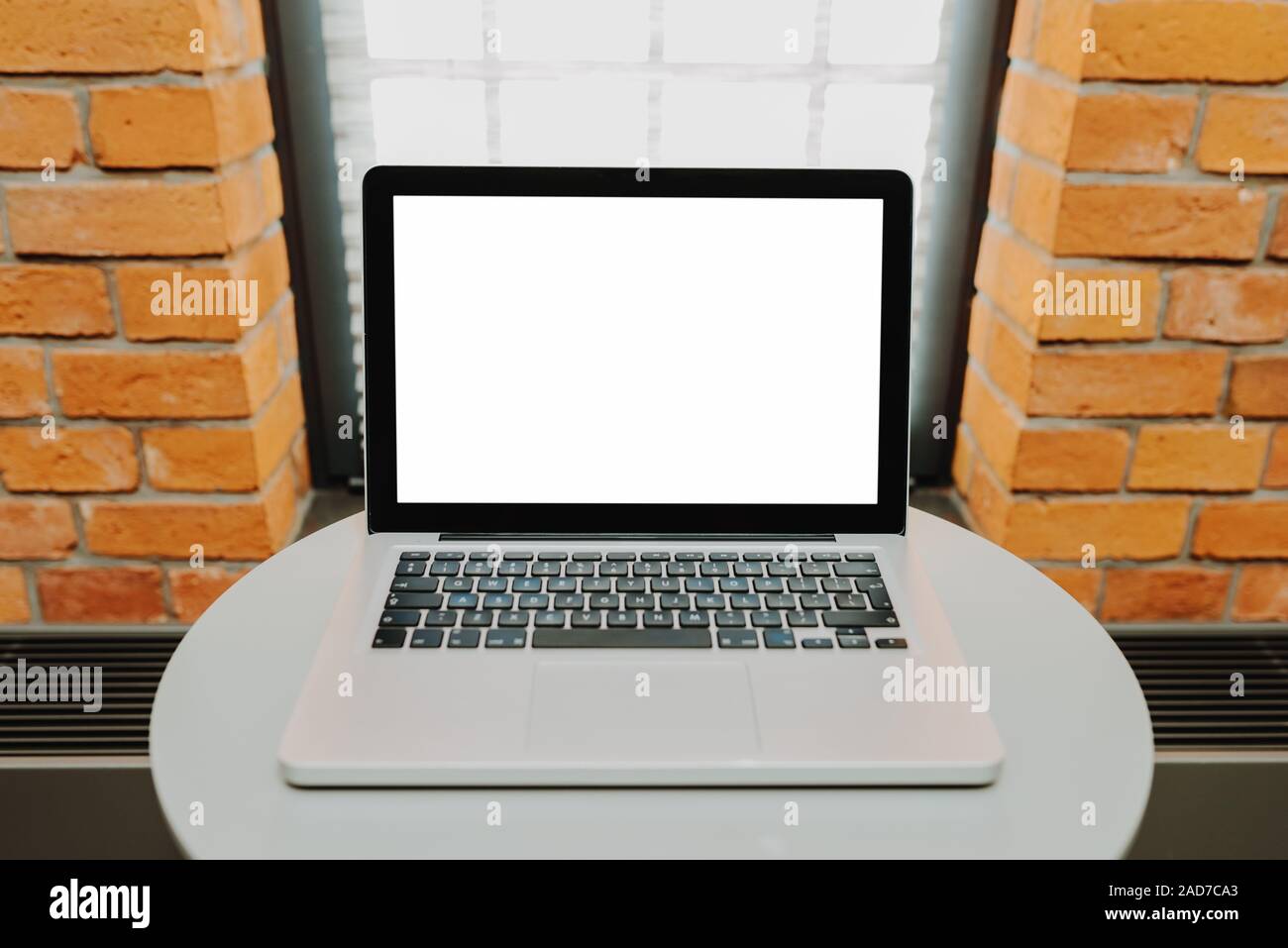 Laptop with blank screen on table Stock Photo