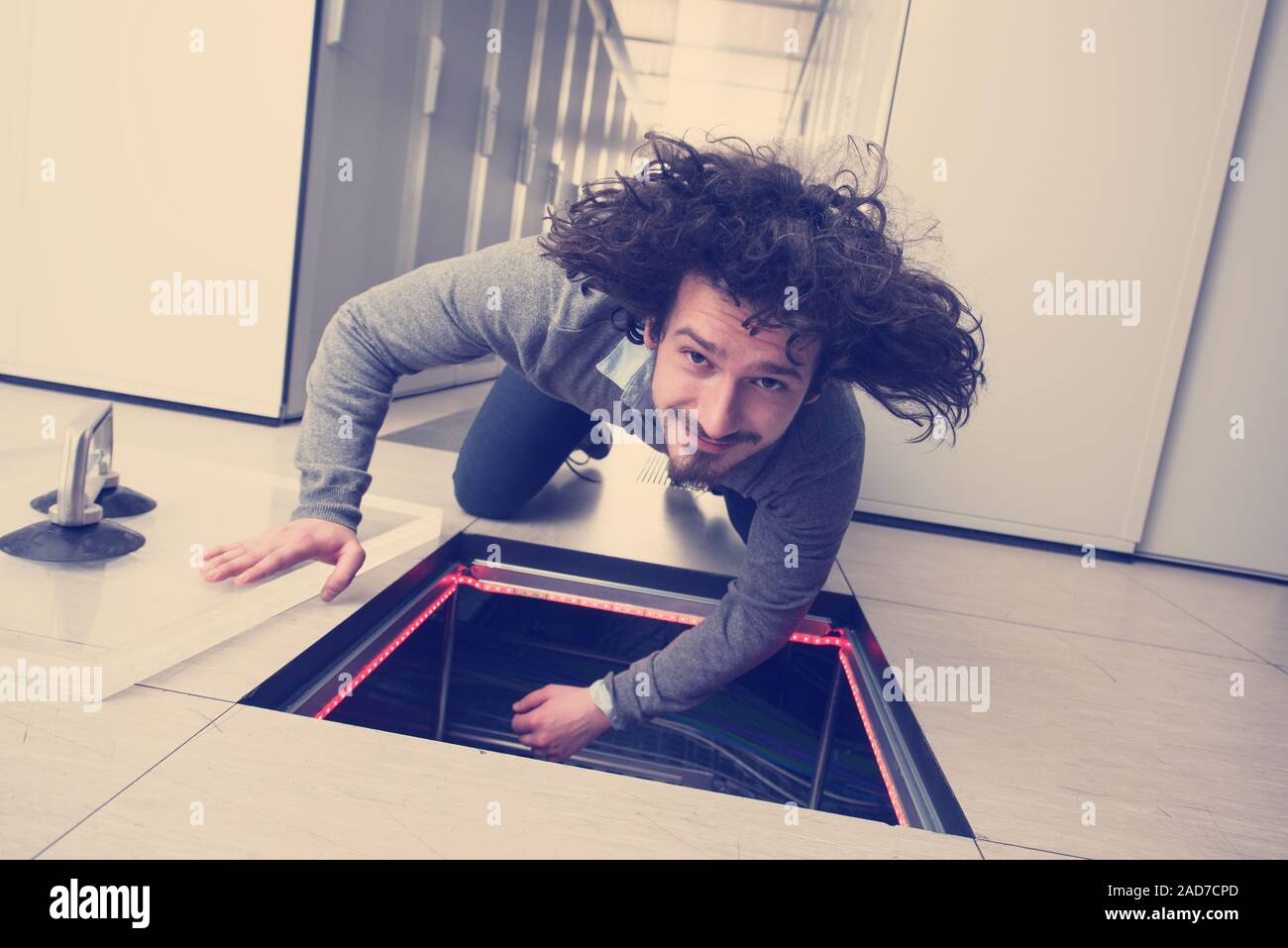 engineer connecting cables in server room Stock Photo