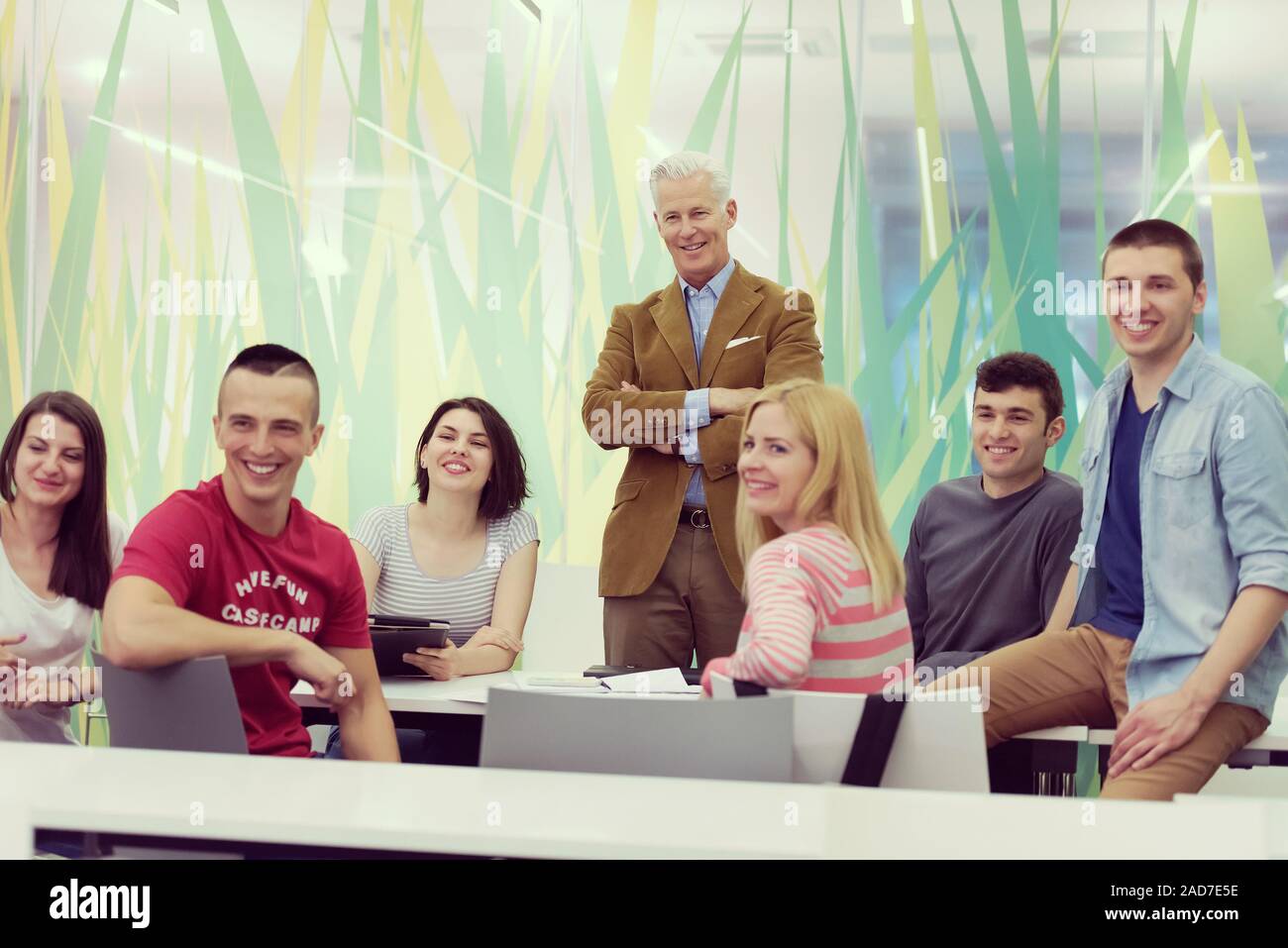 portrait of teacher with students group in background Stock Photo - Alamy