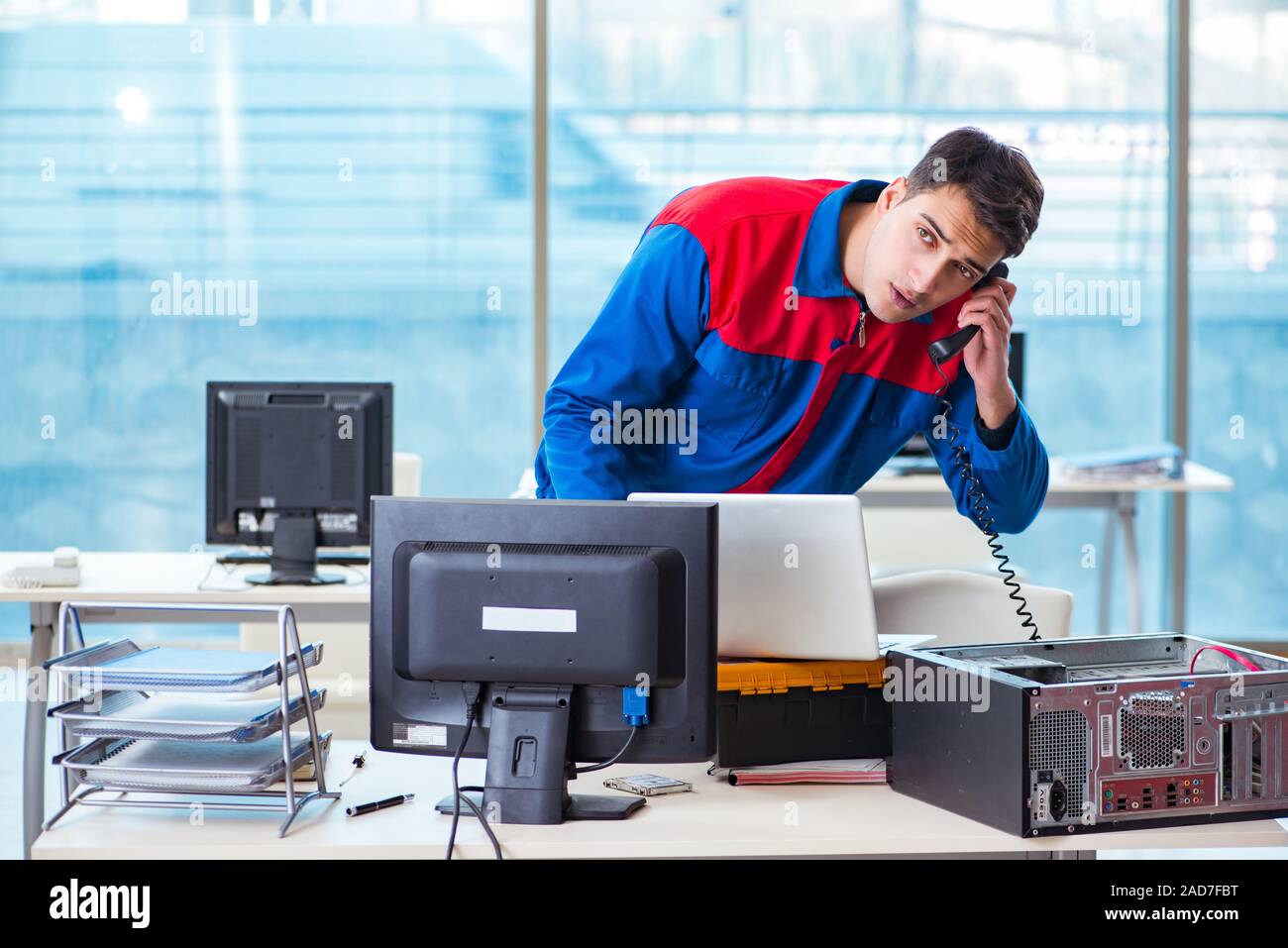 Computer technician repairing broken computer in workshop Stock Photo ...