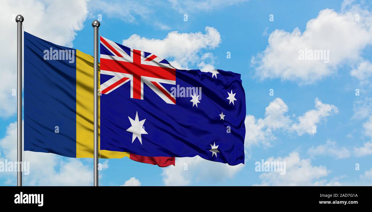 Romania and Australia flag waving in the wind against white cloudy blue sky together. Diplomacy concept, international relations. Stock Photo