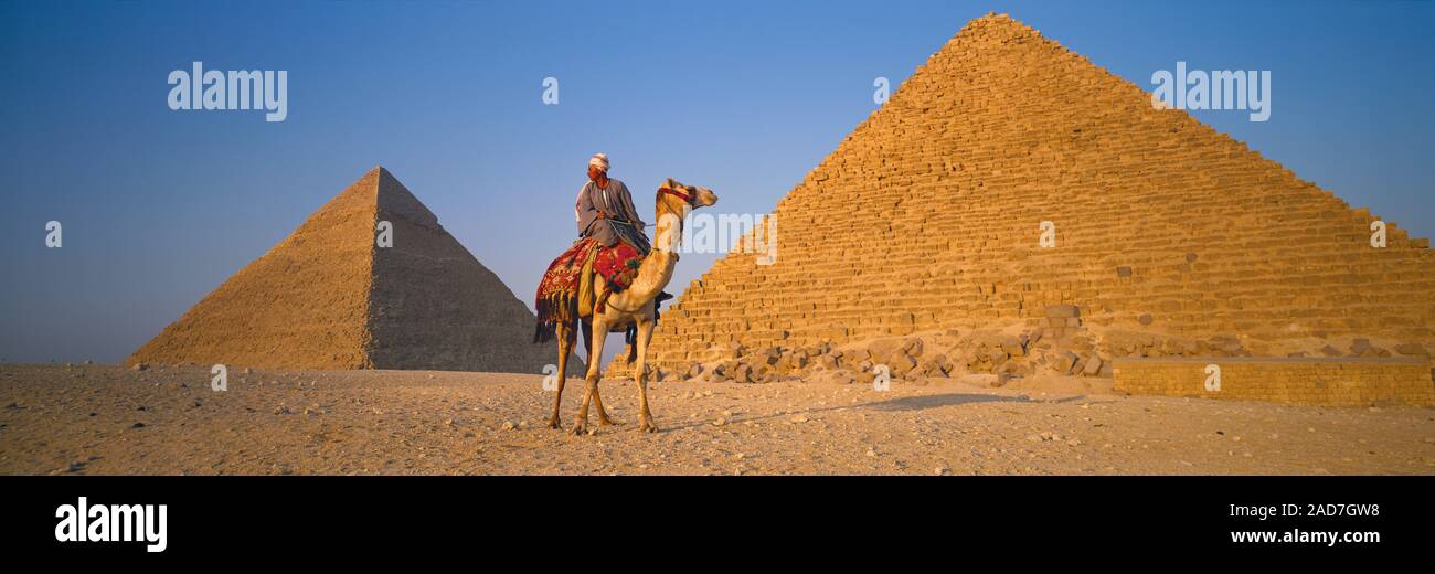 Person riding camel in front of Great Pyramid of Giza, Giza, Egypt Stock Photo