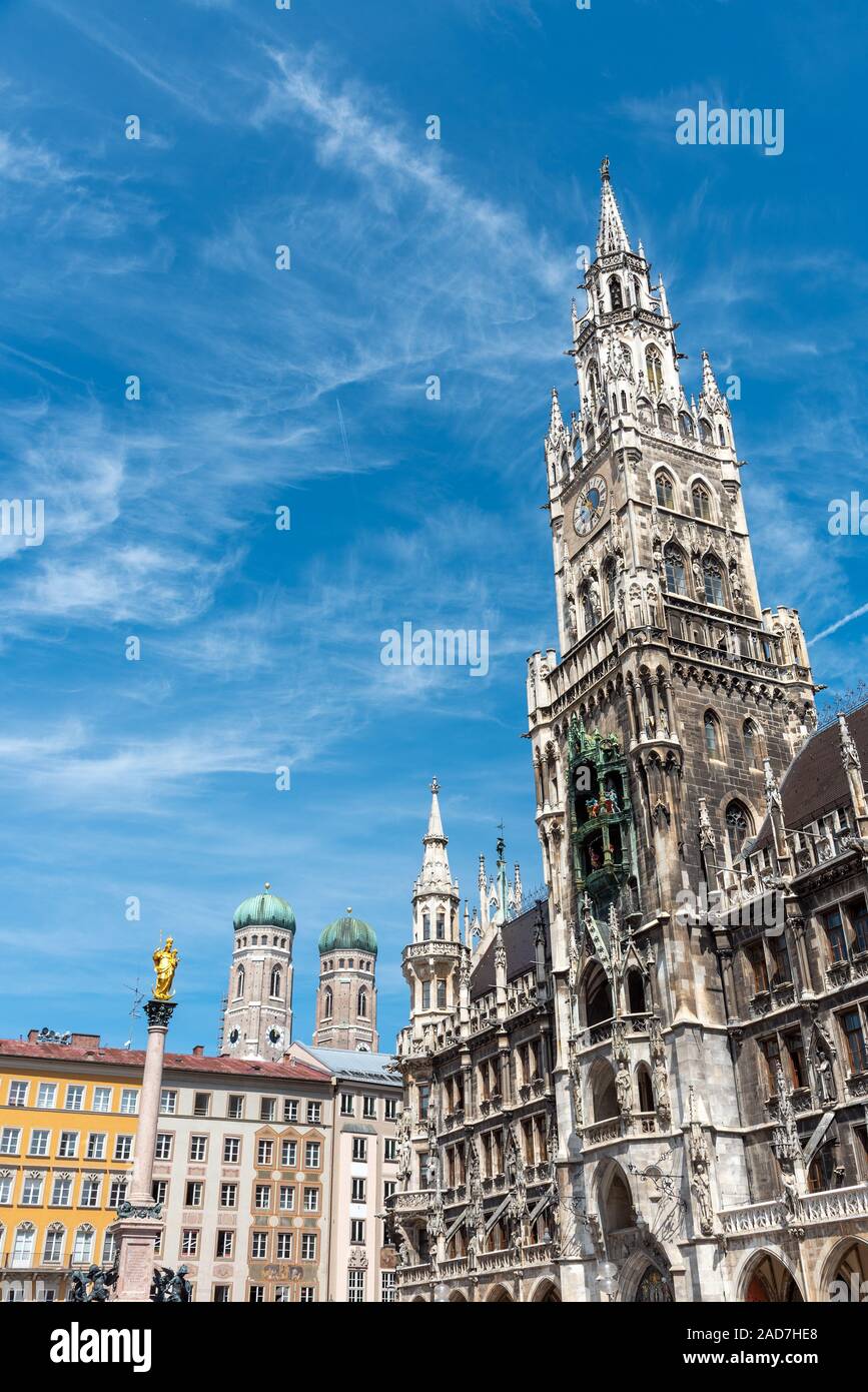 The New City Hall at the Marienplatz in Munich with the towers of the Frauenkirche in the back Stock Photo